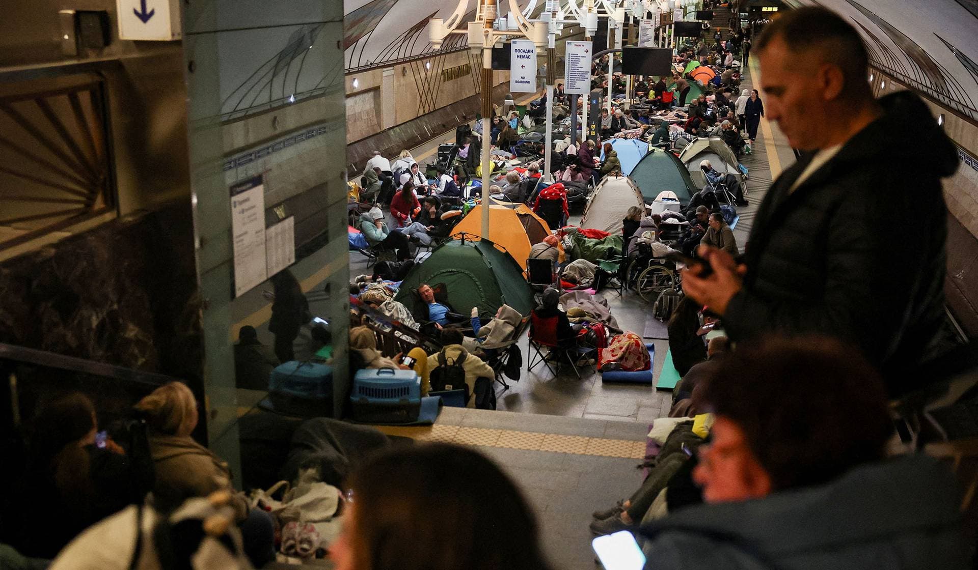 People take shelter inside a metro station during a Russian air strike in Kyiv