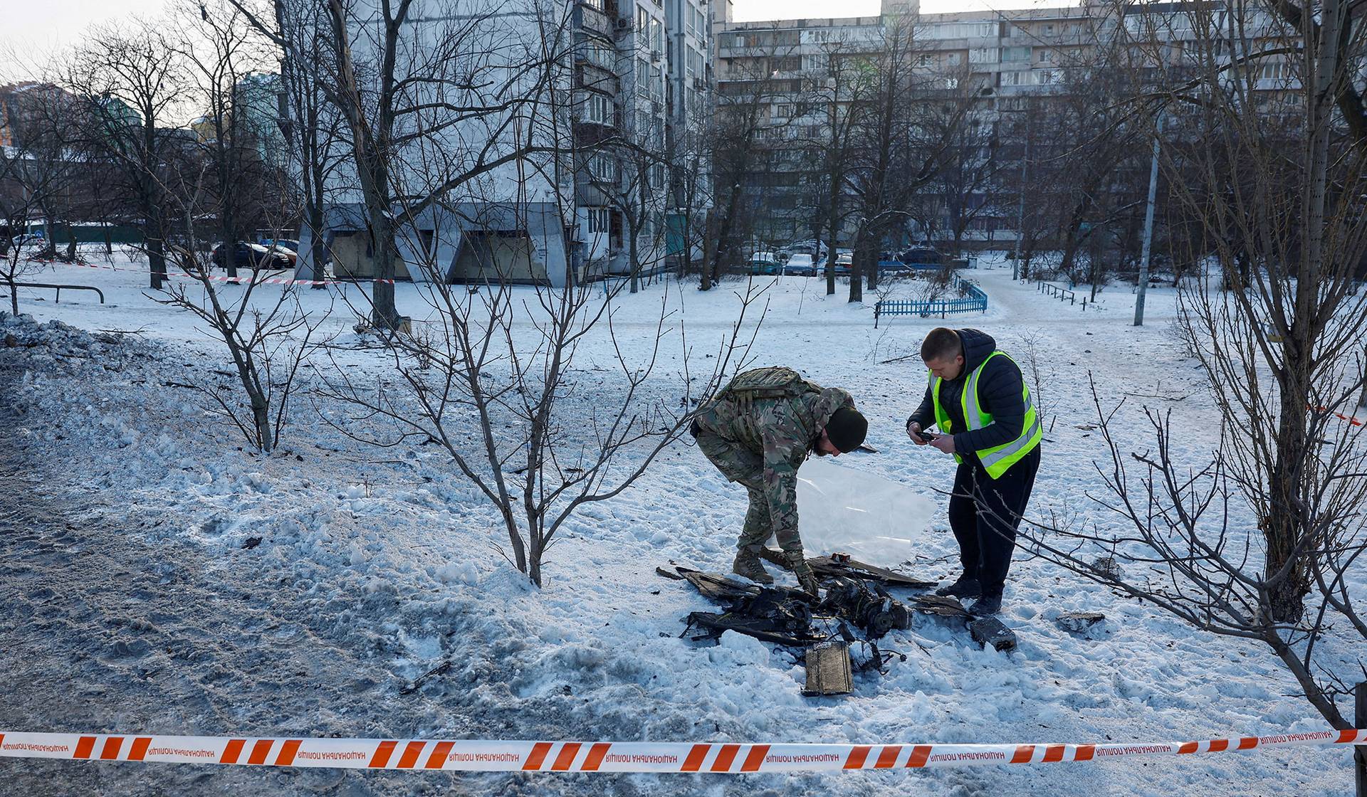 Police officers inspect the remains of a suicide drone after Russian overnight strikes in Kyiv