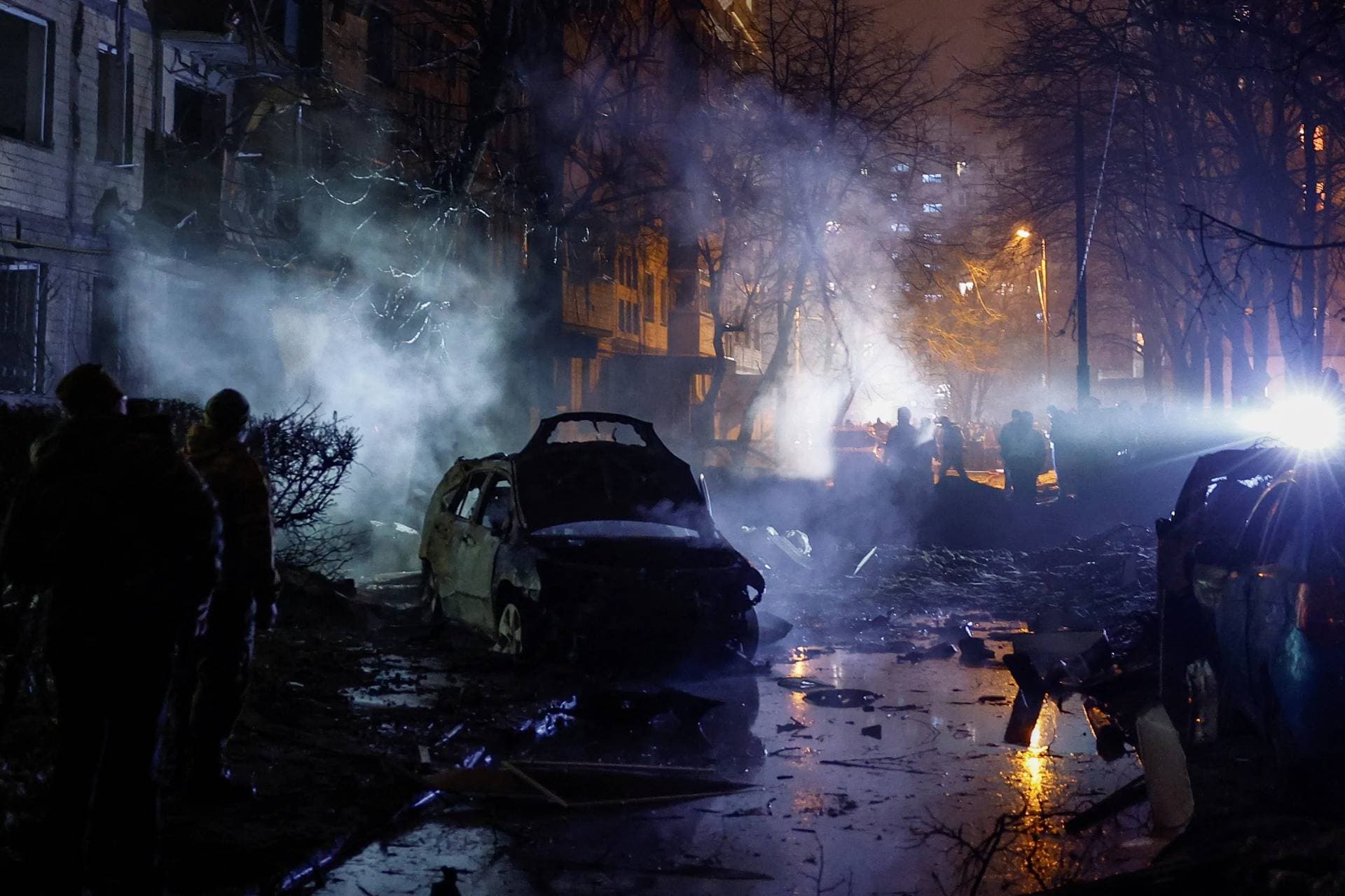 Emergency staff work at an apartment building damaged during the attack