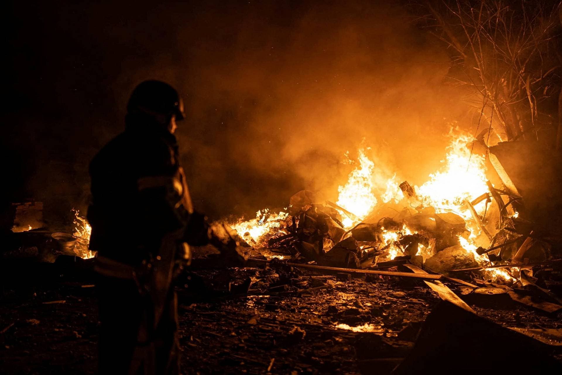 firefighters put out fire caused by fragments of a Russian rocket after it was shot down by air defense system during the night Russian rocket attack in Kyiv
