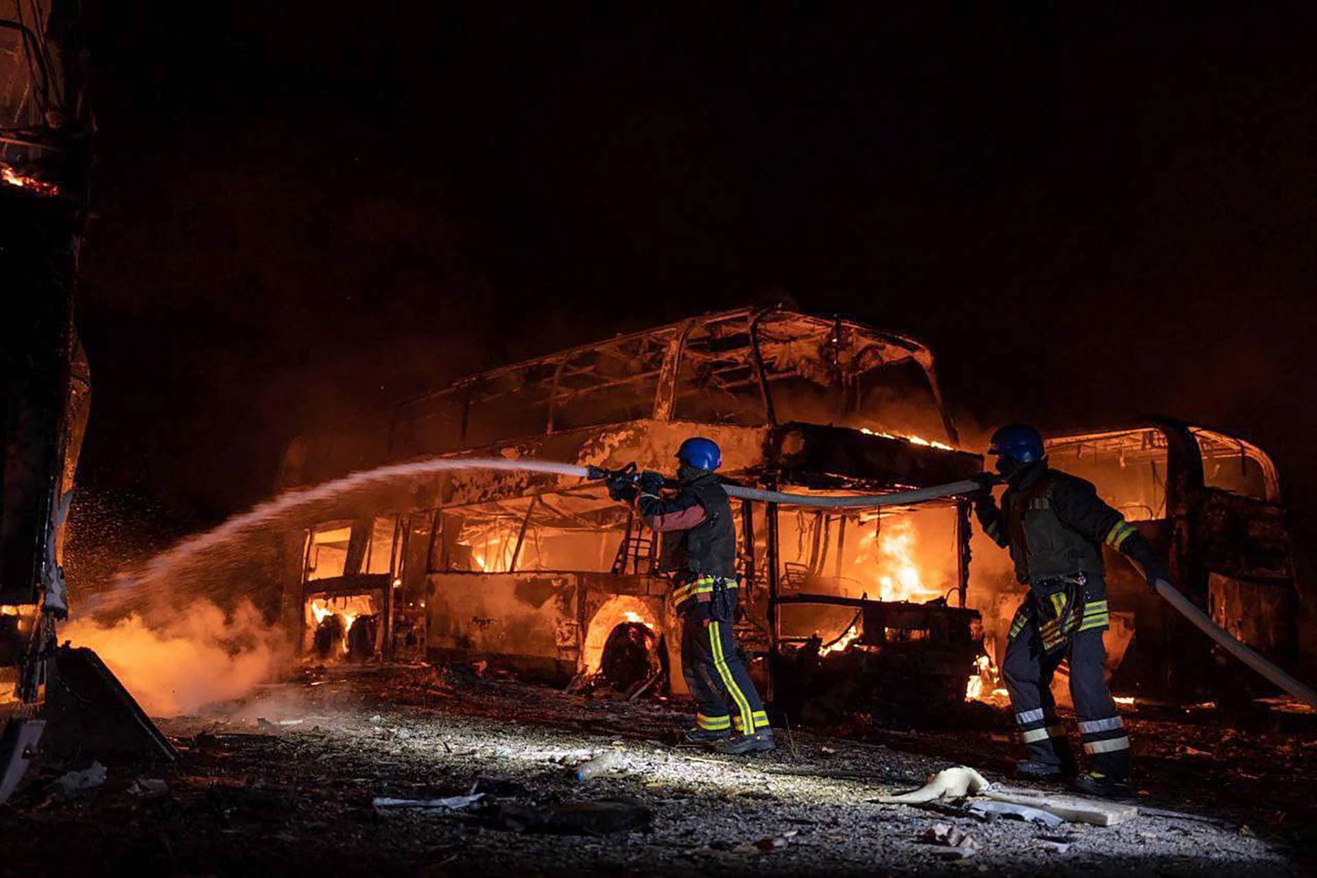 firefighters put out fire caused by fragments of a Russian rocket after it was shot down by air defense system during the night Russian rocket attack in Kyiv