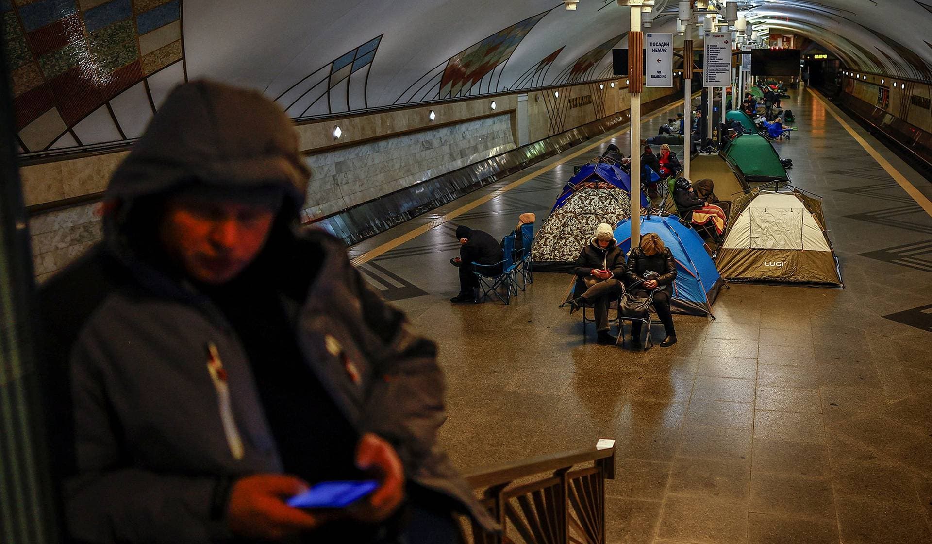 People take shelter inside a metro station during a Russian overnight missile and drone strike in Kyiv