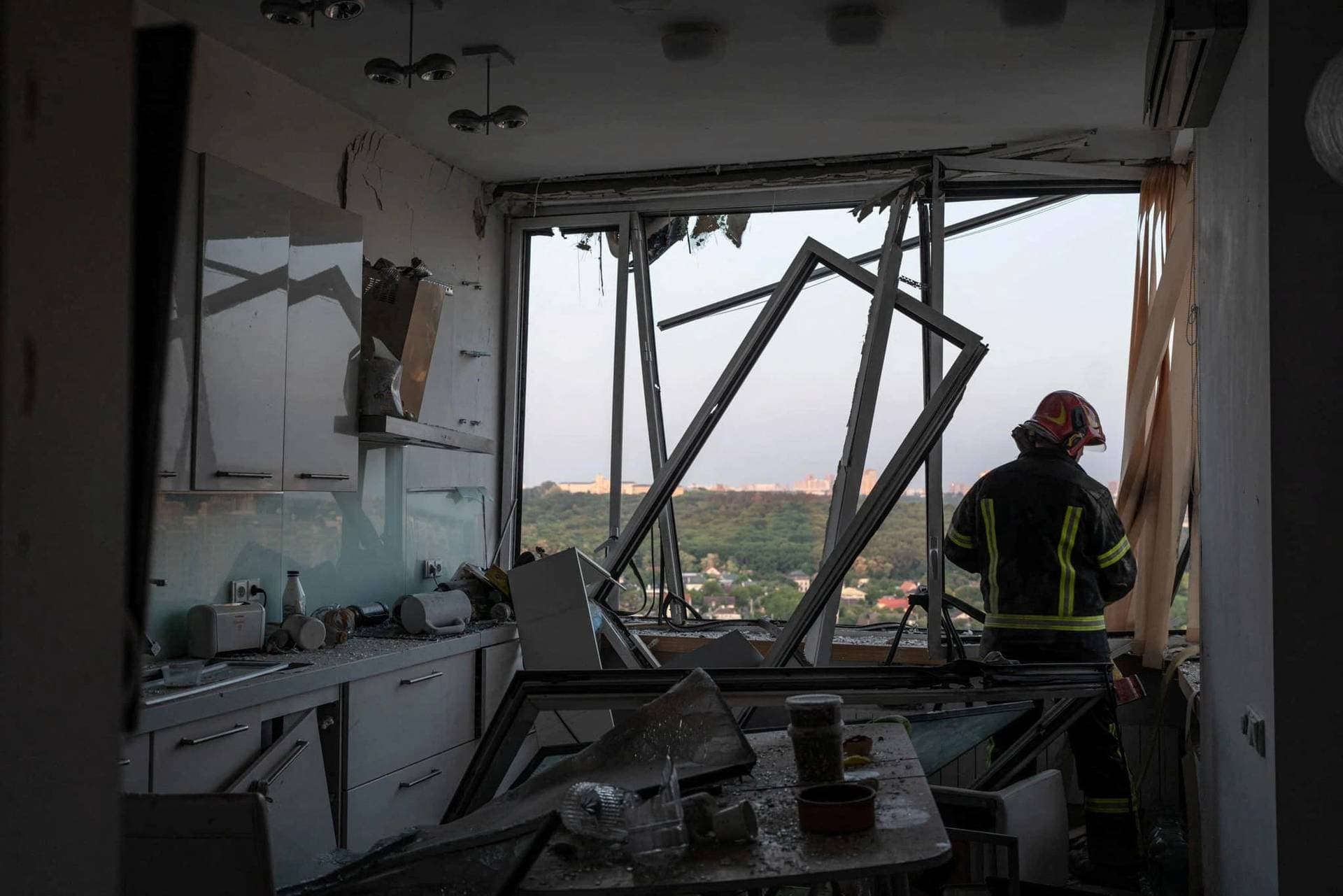 A rescuer works inside an apartment building which was damaged during a Russian drone attack in Kyiv