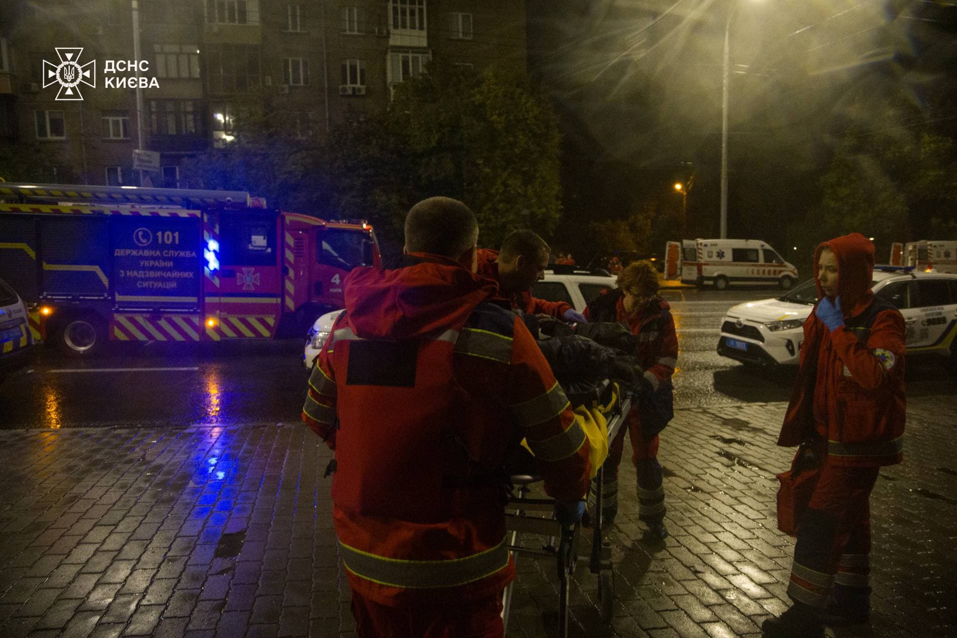 Rescuers evacuate a resident from an apartment building damaged by a Russian drone strike in Kyiv