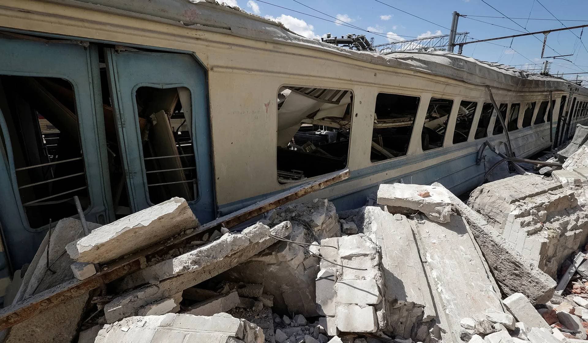 Debris lies next to a train carriage damaged during a Russian drone strike at a railway station in Lozova