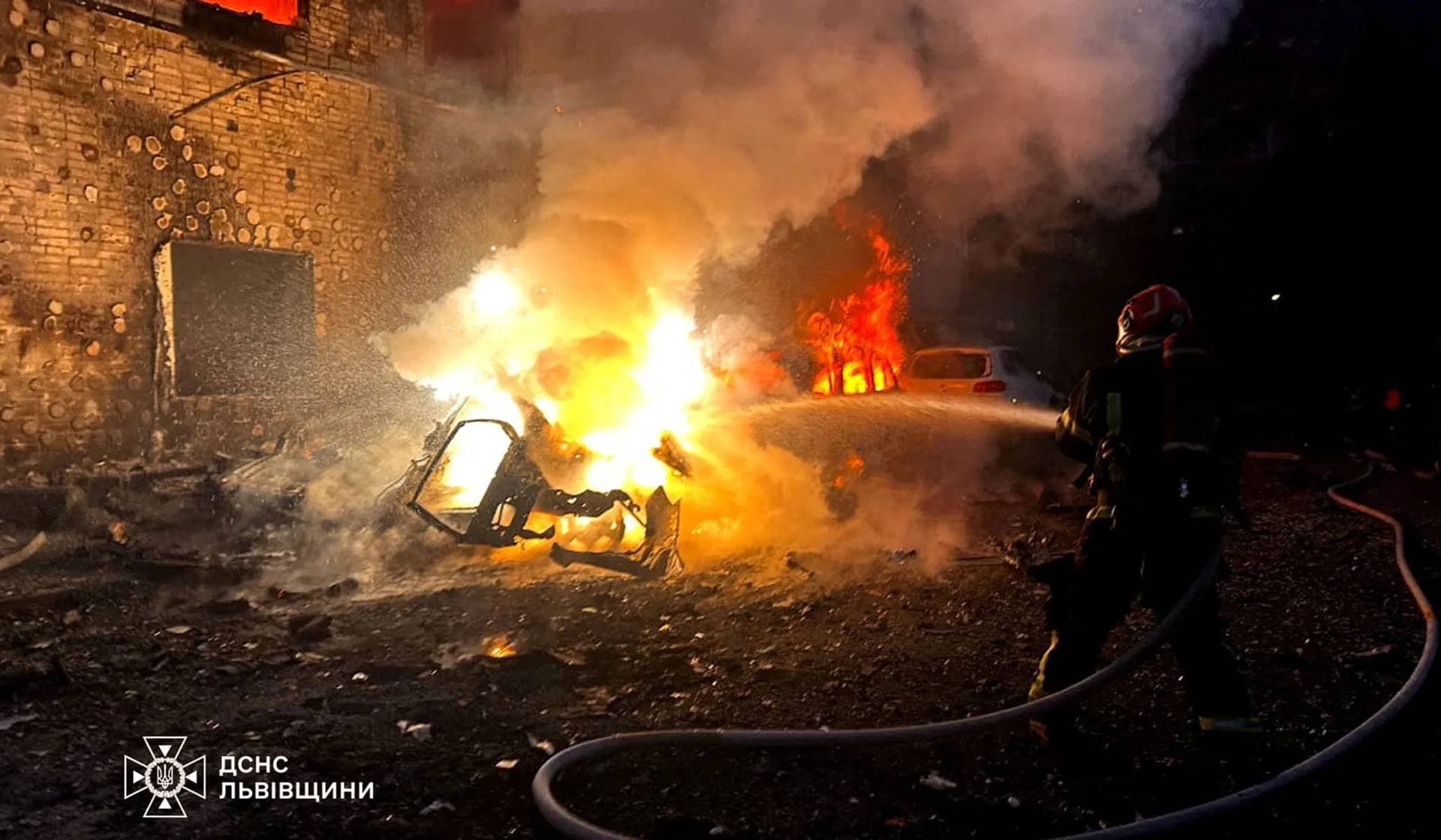 A firefighter works at the site of a Russian drone strike in Lviv