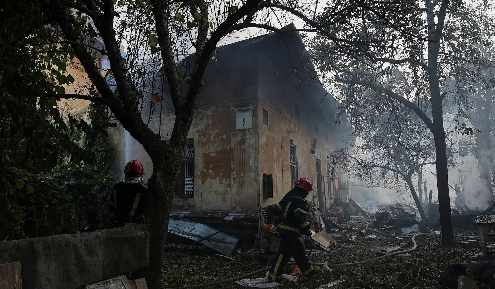 Rescuers work at the site of a residential building damaged during a Russian drone and missile strike in Lviv