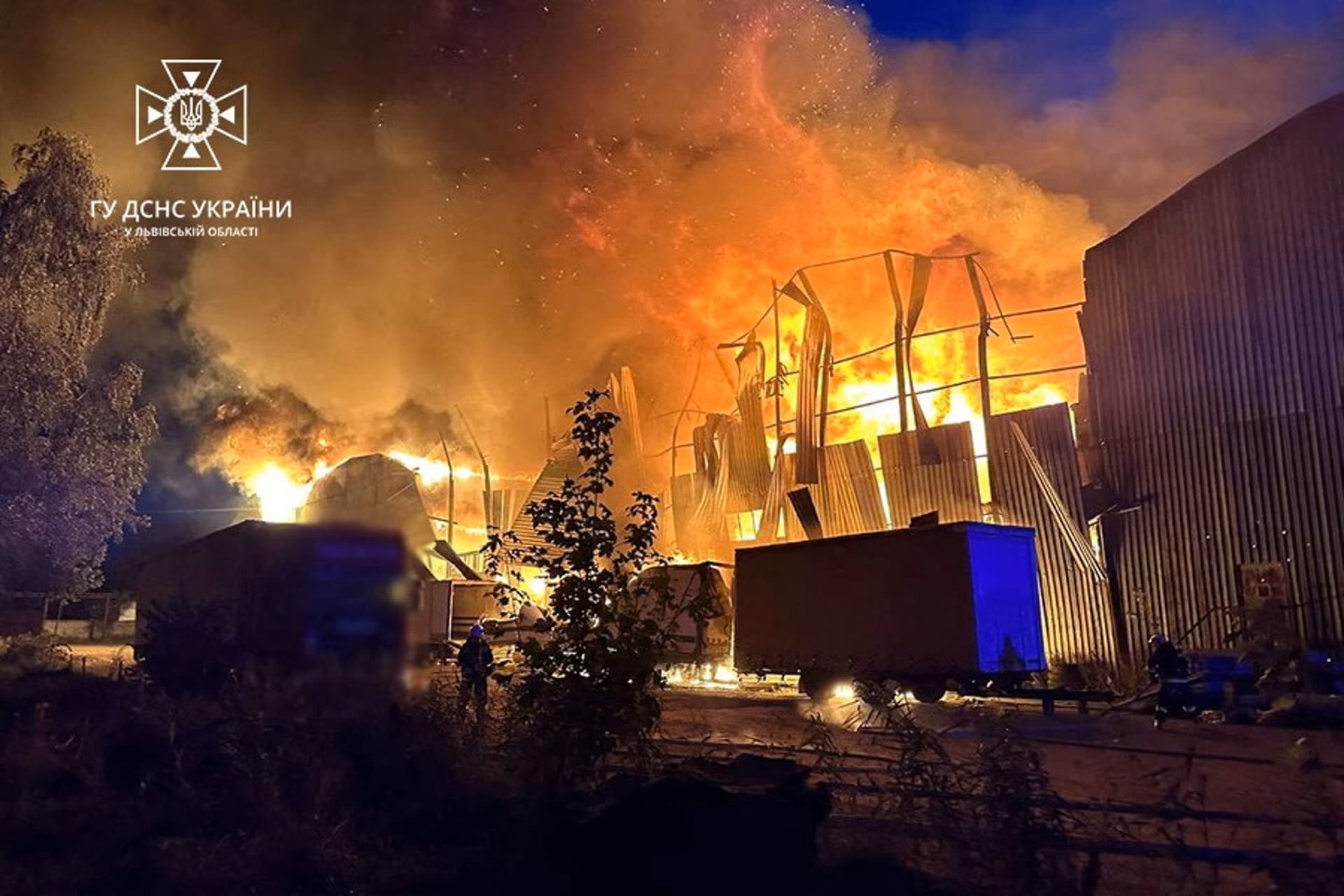 Firefighters work at a site of an industrial warehouse damaged by a Russian drone strike in Lviv