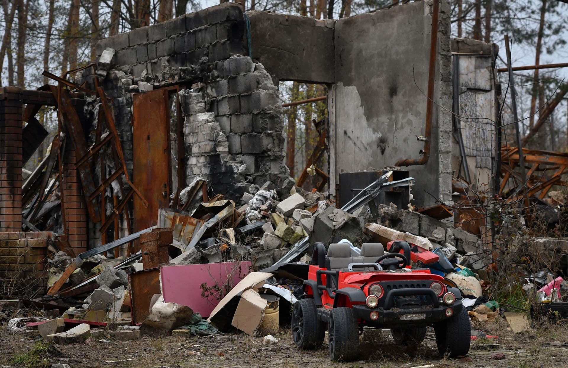 A toy car is seen near heavily damaged garage in the recently recaptured village of Yampil