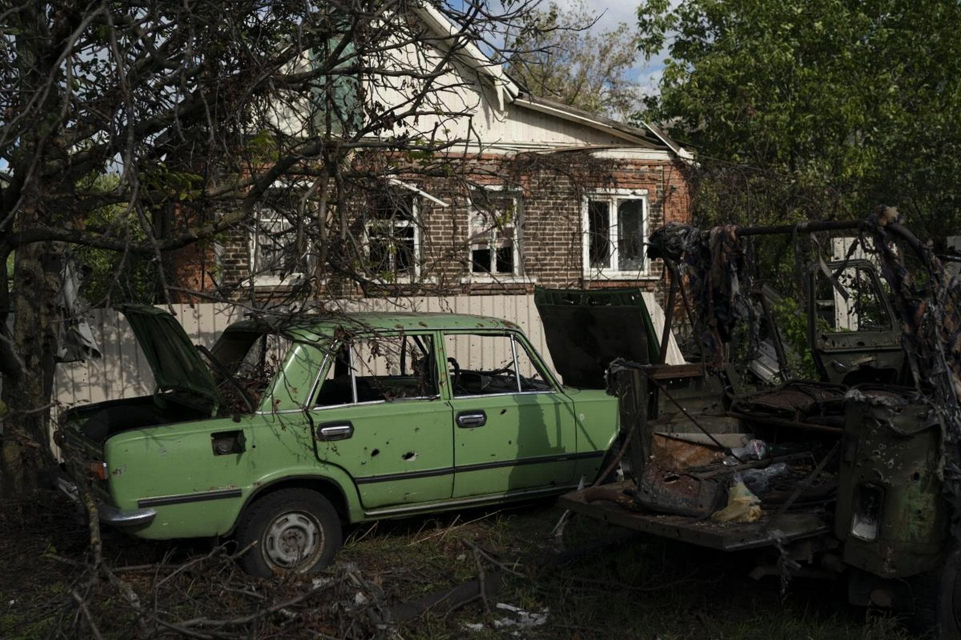 Damaged cars in the retaken village of Shchurove