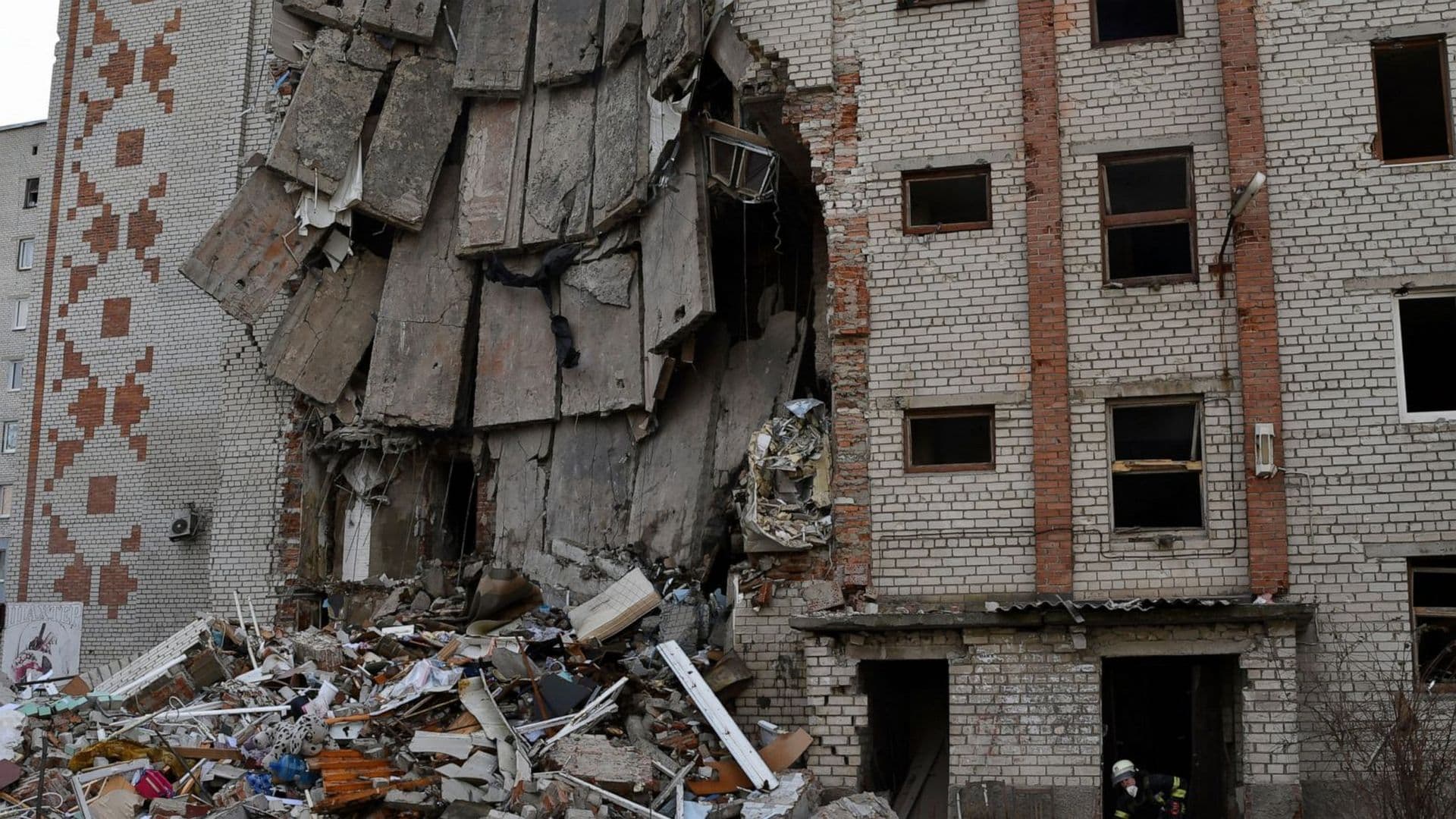 Firefighters work at the scene of a damaged residential building after Russian shelling in the liberated Lyman