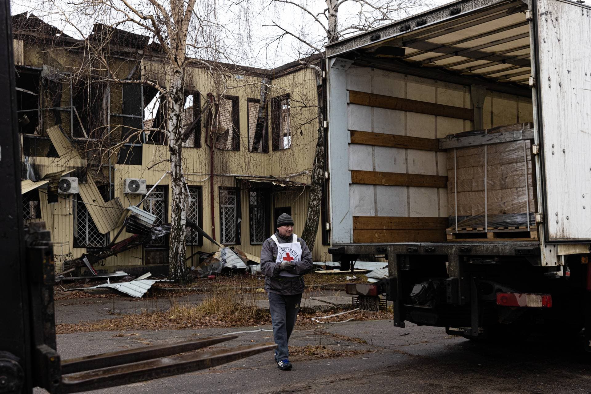 Red Cross trucks deliver dry fuel bricks to help residents of Lyman heat their homes