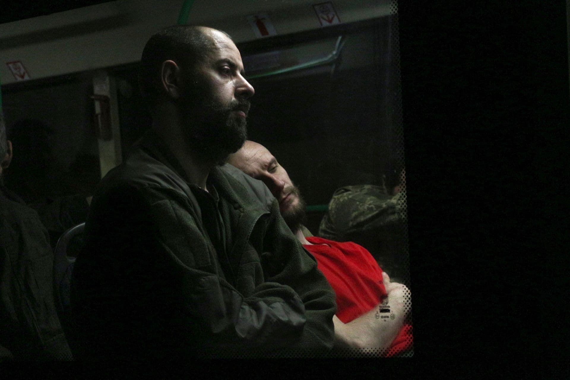 Ukrainian servicemen sit in a bus after leaving Mariupol's besieged Azovstal steel plant