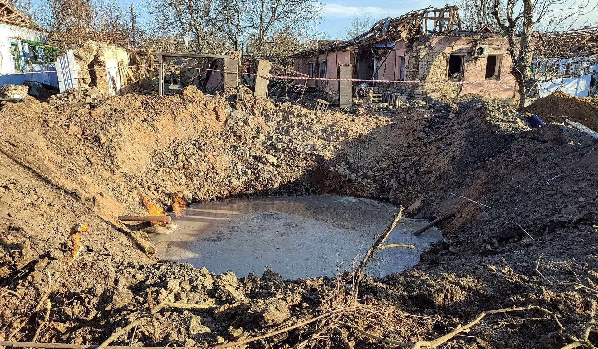 A crater and buildings damaged during a Russian missile strike in Mykolaiv