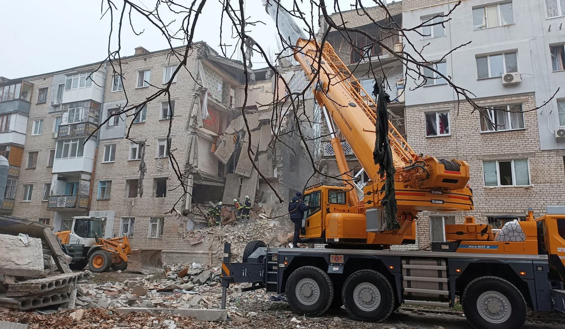 Rescuers work at a site of a residential building heavily damaged by a Russian missile attack in Mykolaiv