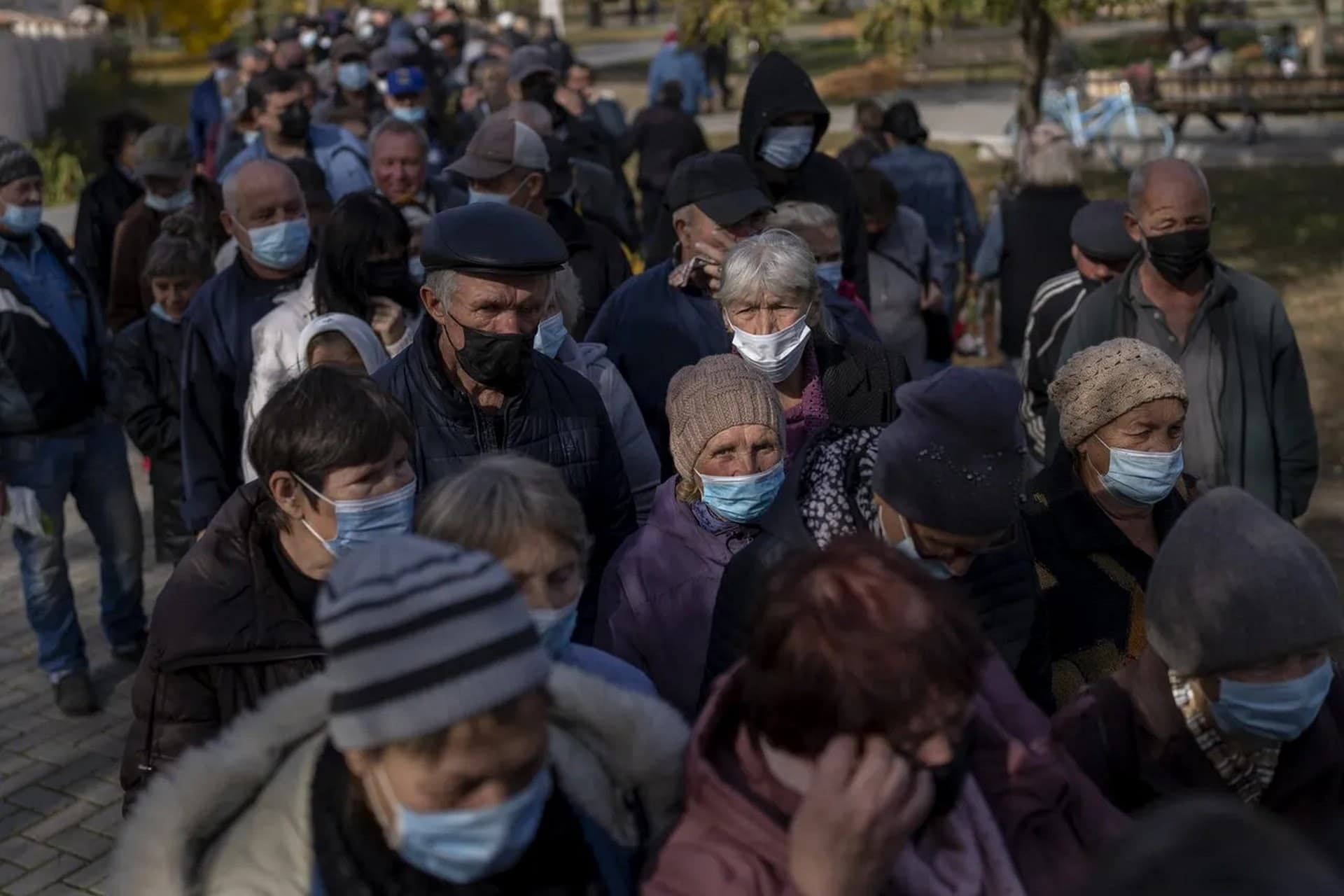 People queue up to wait a ration food from World Central Kitchen organisation in the center of Mykolaiv