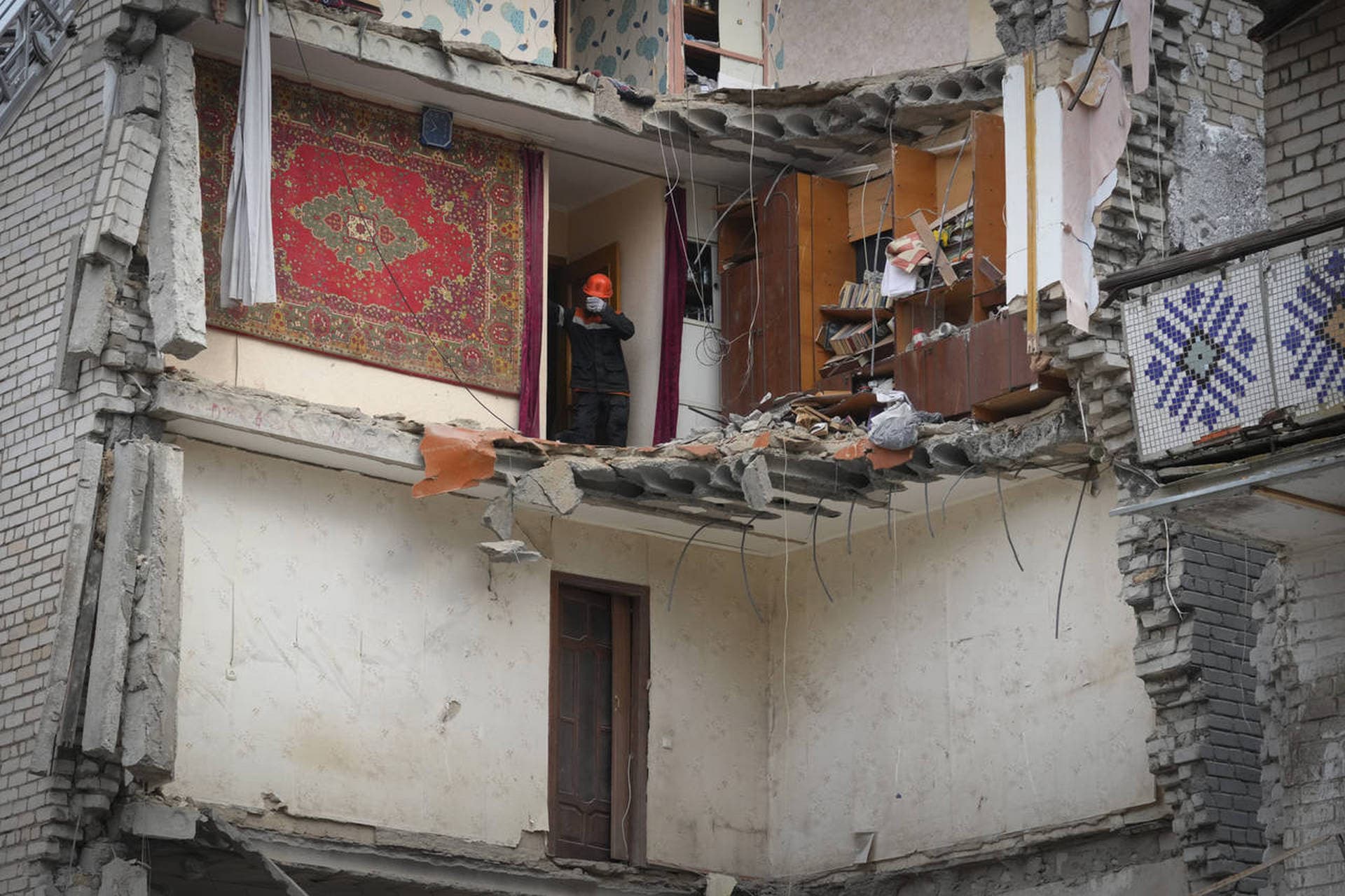 A Ukrainian Emergency Service rescuer inspects a building damaged by Russian shelling in Mykolayiv