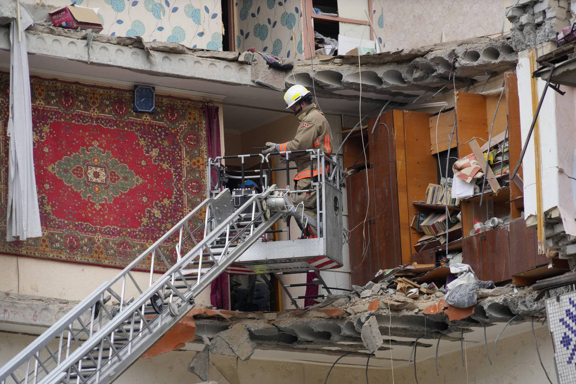 A Ukrainian Emergency Service rescuer inspects a building damaged by Russian shelling in Mykolayiv