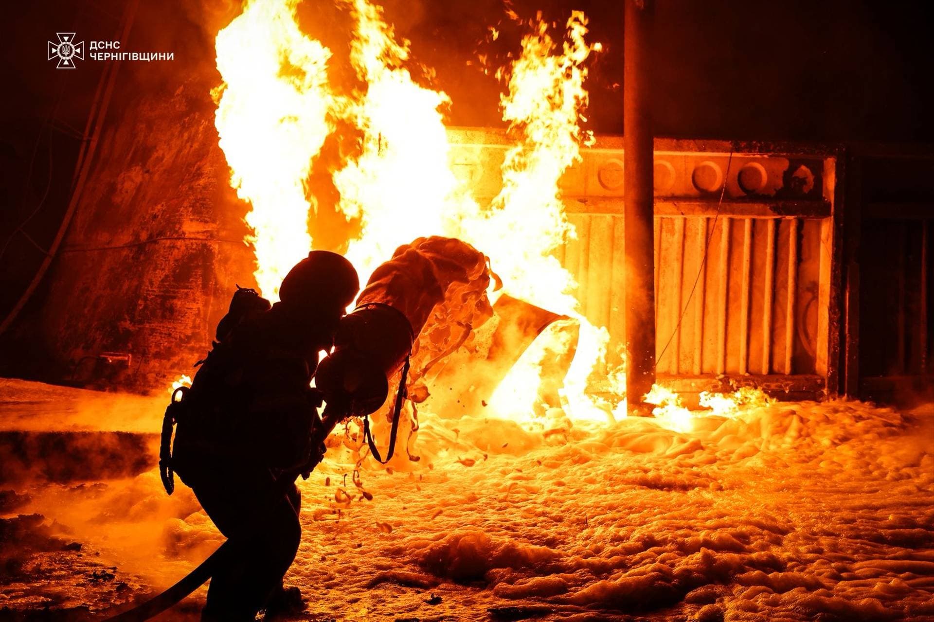 A firefighter works at the site where a critical infrastructure facility was hit by Russian drone strikes near the town of Nizhyn