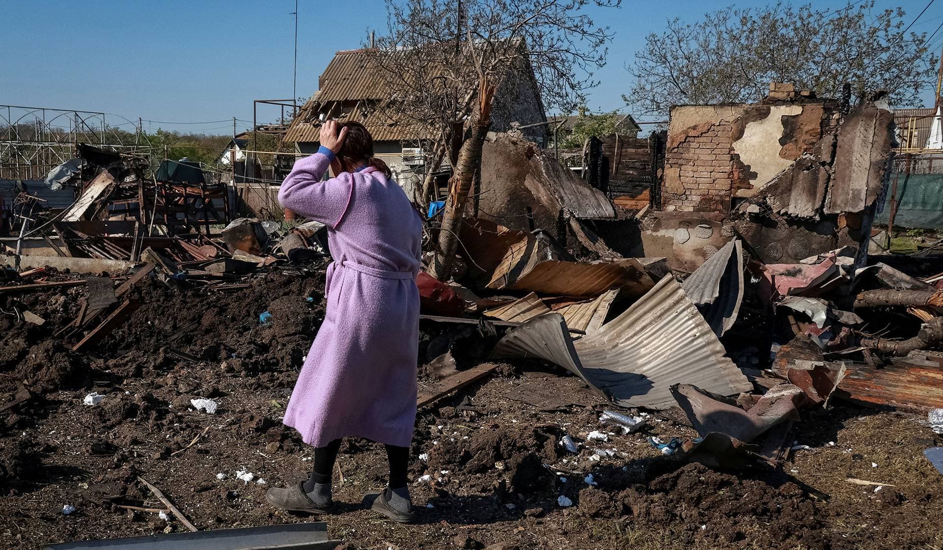 A resident walks at the site of a Russian drone strike near the city of Chornomorsk