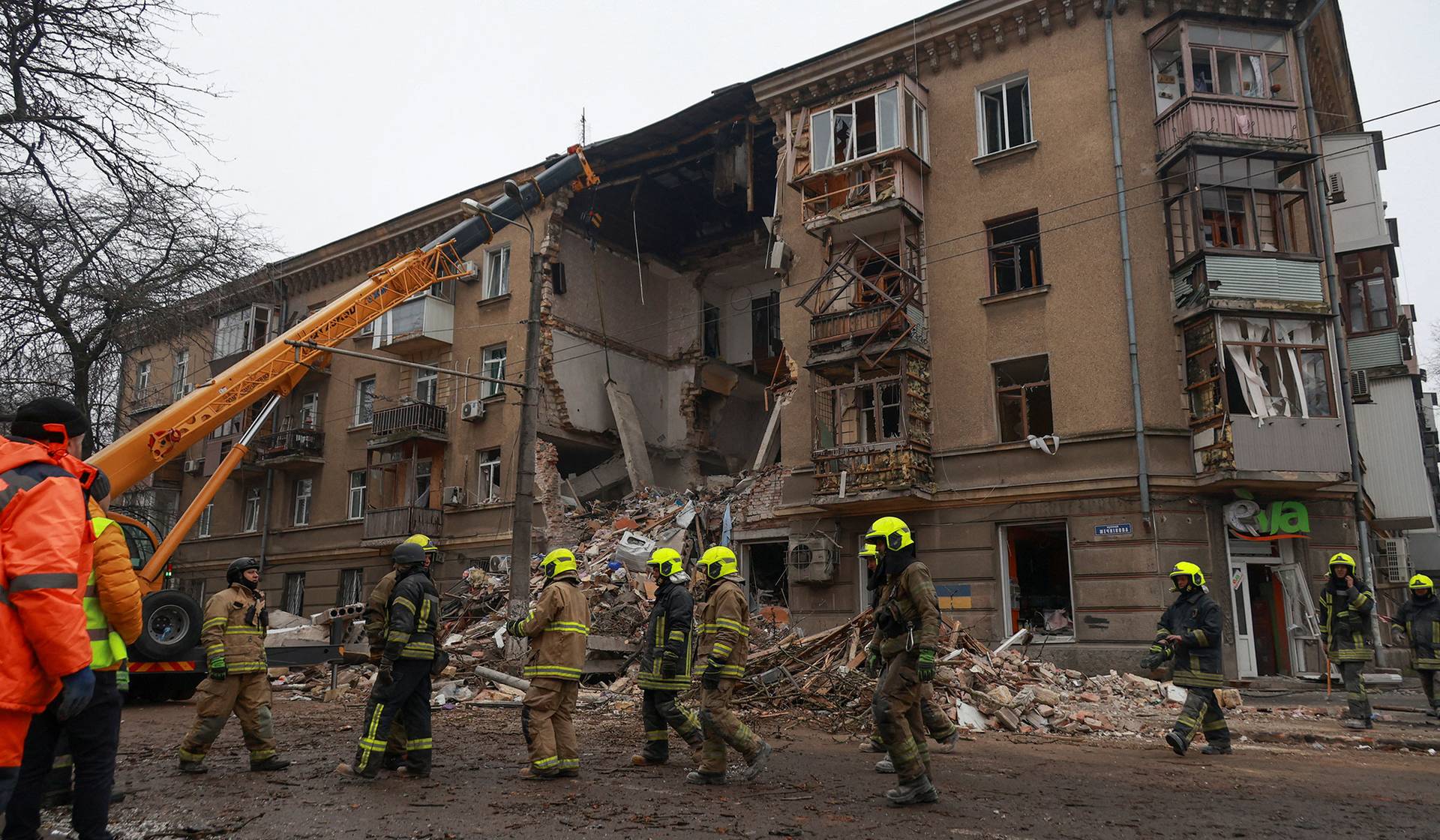 Rescuers work at the site of an apartment building hit during overnight Russian drone strikes in Odesa