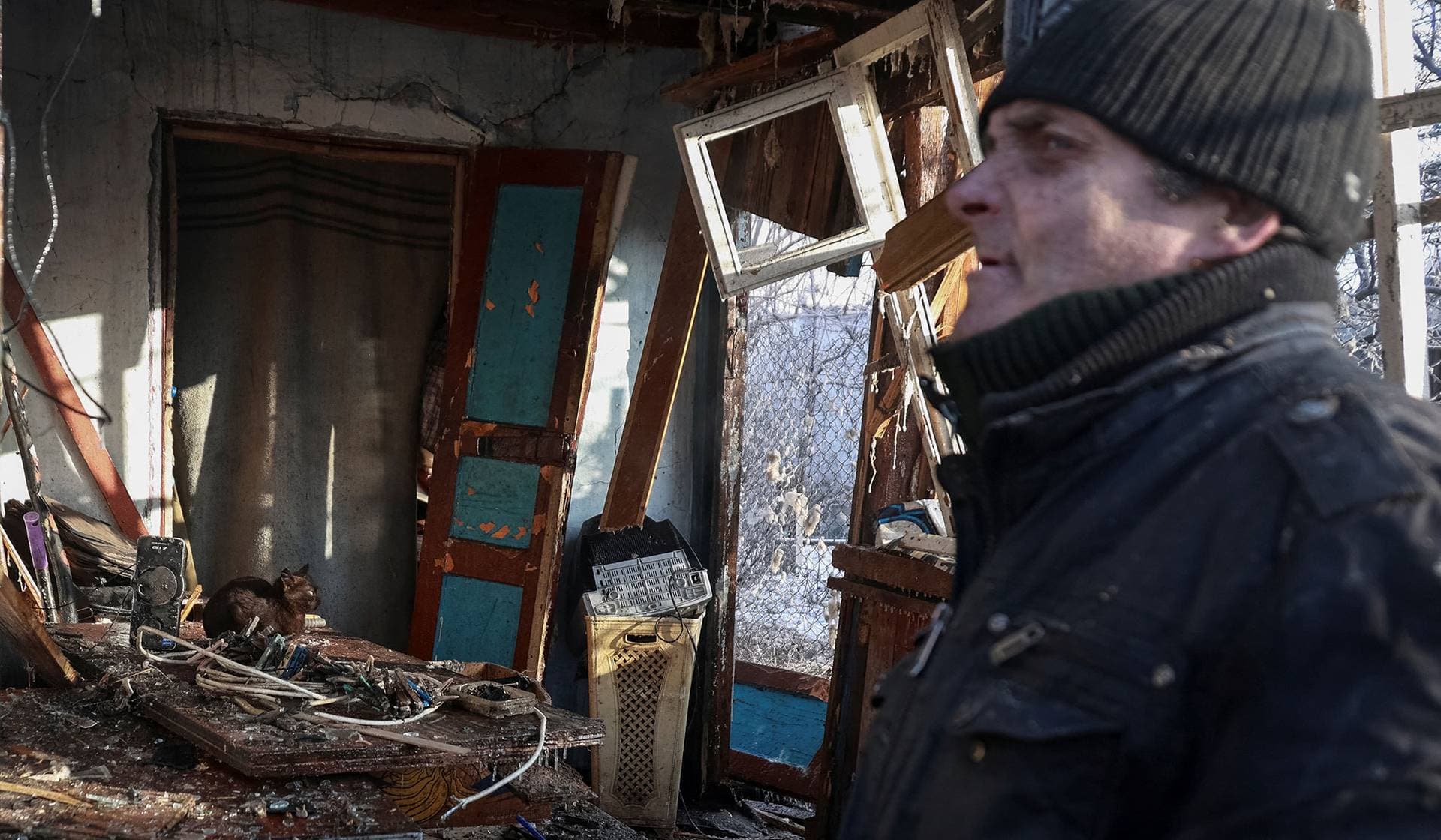 A resident stands at the site of the Russian drone strike near Chornomorsk