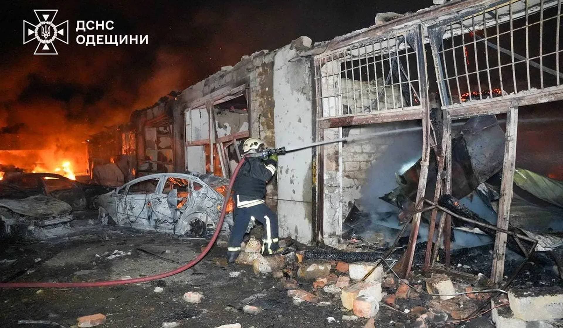 A firefighter works at the site of a private enterprise hit by a Russian drone strike in Odesa
