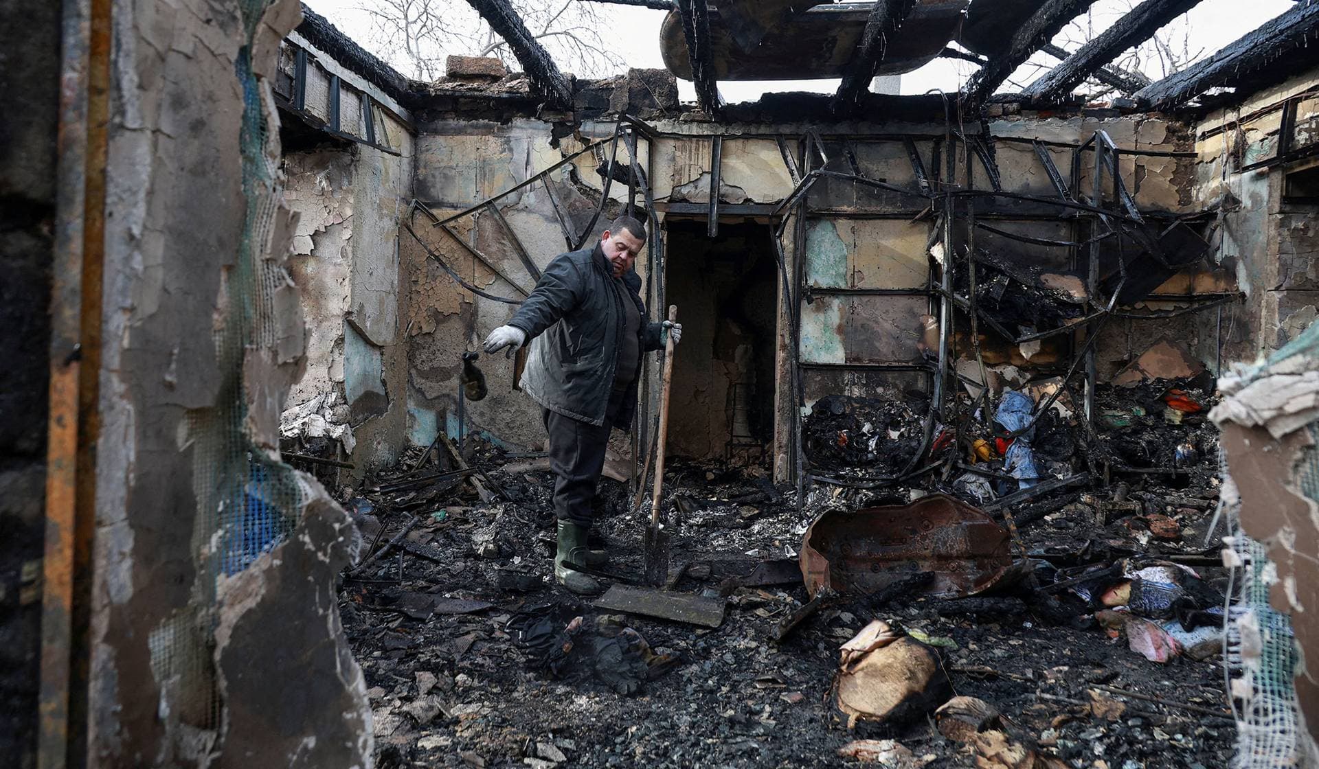 A resident removes debris from his house, which was hit by a Russian drone strike in Odesa