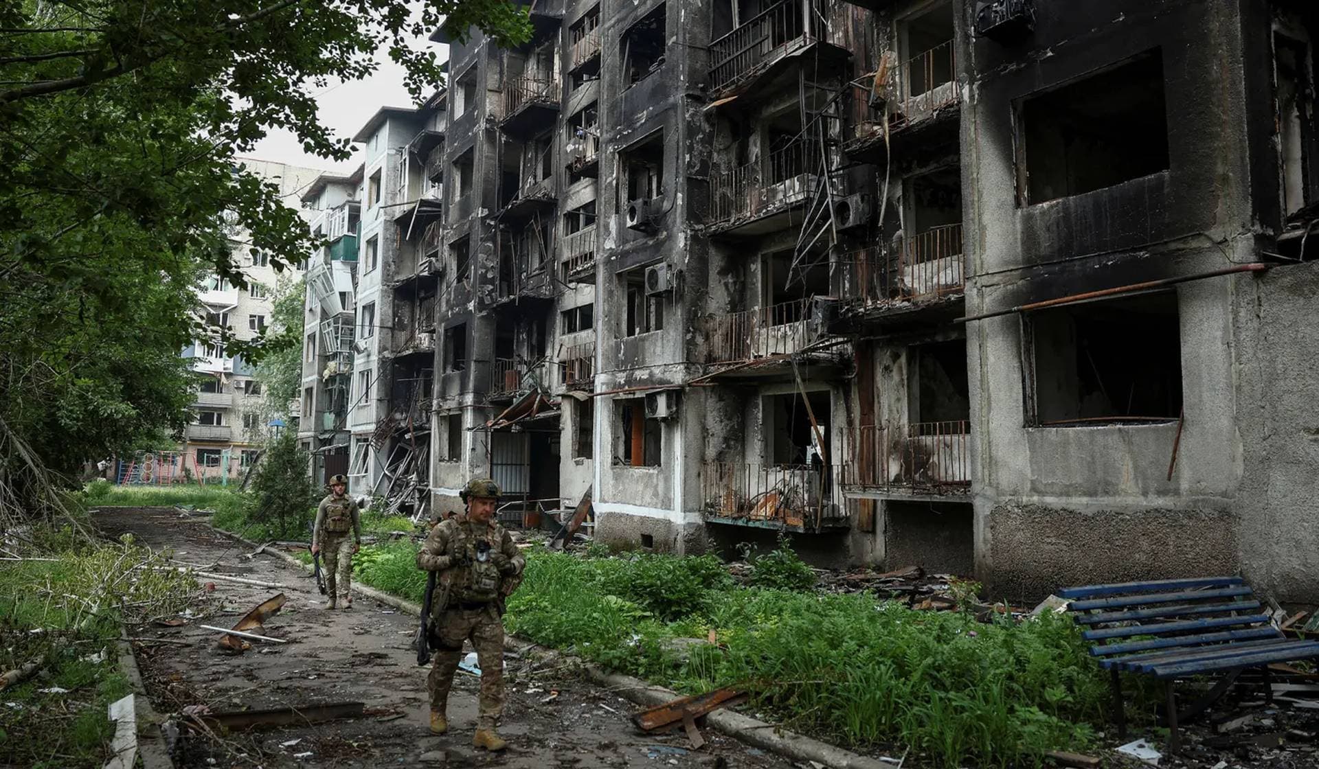 Members of the White Angel unit of Ukrainian police officers who evacuate people from frontline towns and villages check an area for residents in Pokrovsk