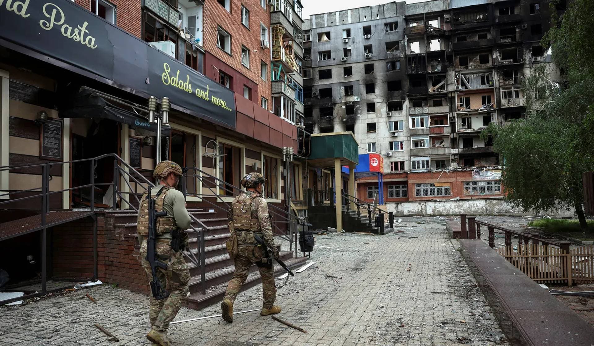 Members of the White Angel unit of Ukrainian police officers who evacuate people from frontline towns and villages check an area for residents in Pokrovsk