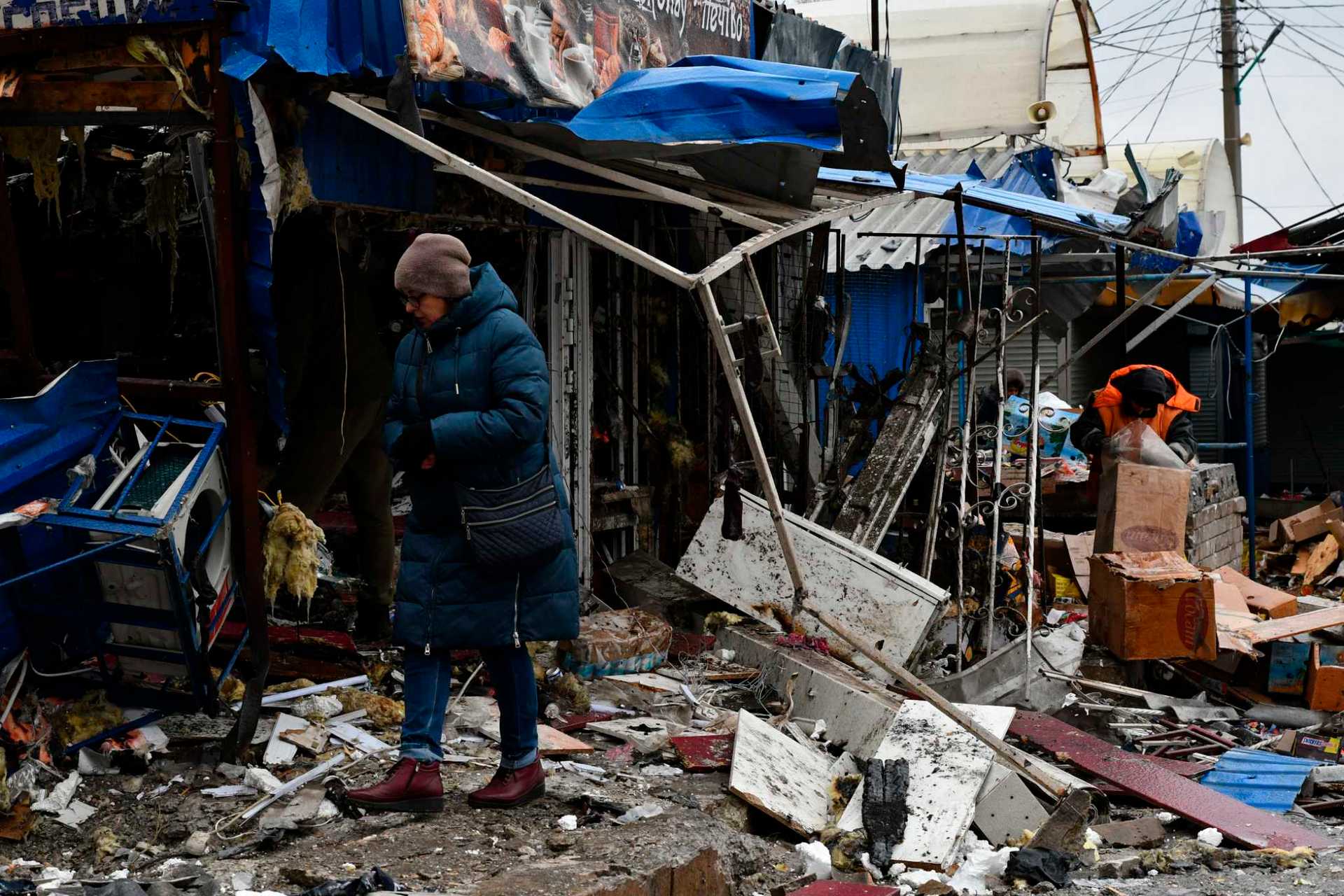 A woman passes by a city market that was damaged following Wednesday's Russian shelling, in Kurakhove