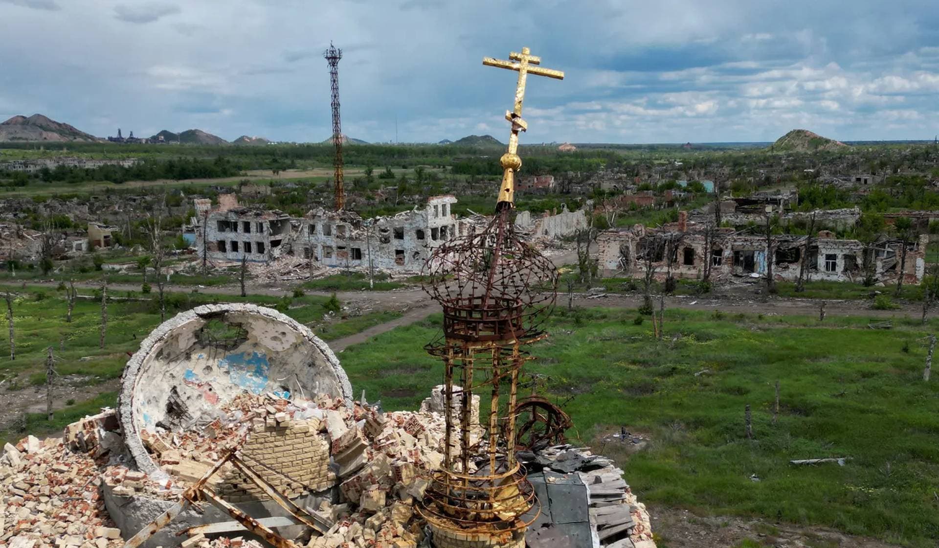 Drone view of the ruins of a church and buildings in the abandoned town of Marinka (Maryinka)