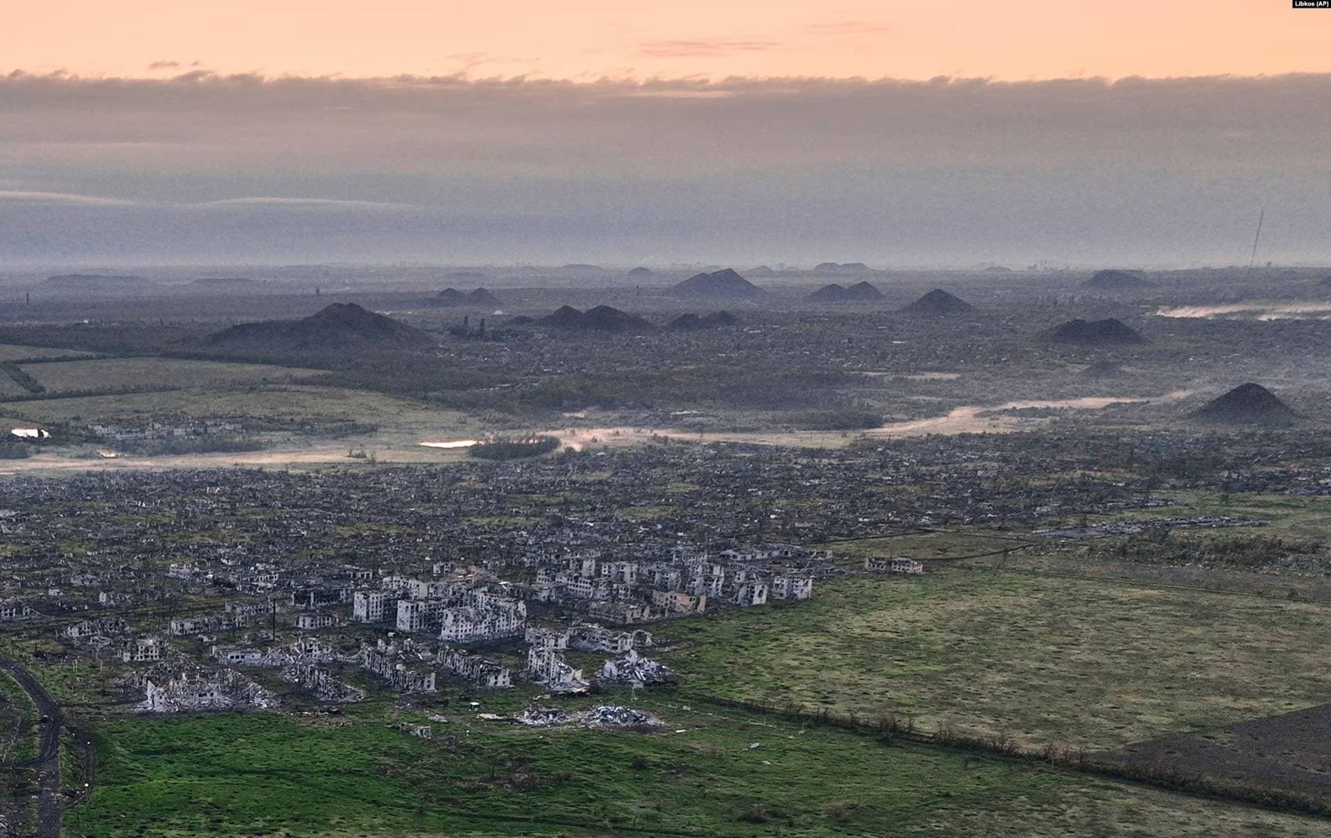 The ruins of Maryinka with towering slag heaps from local coal mines in the background