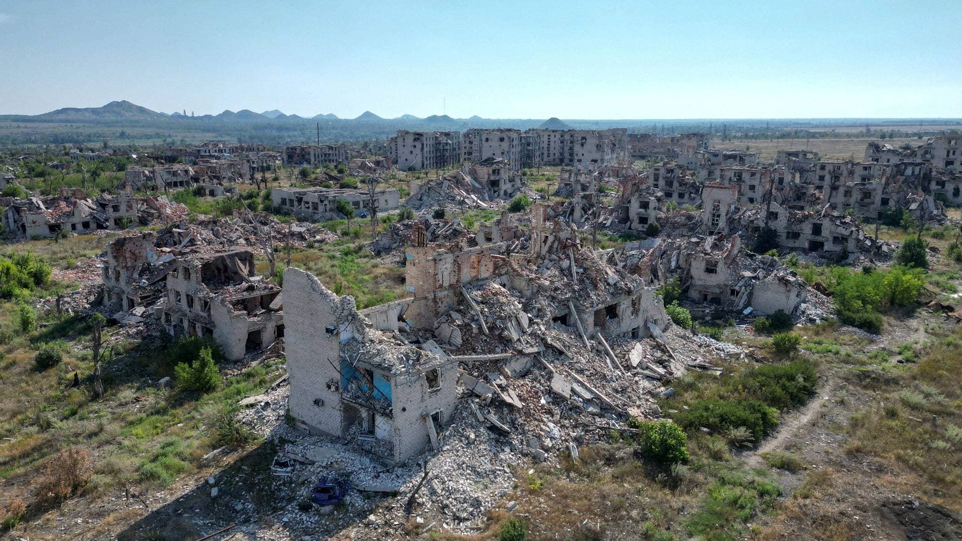 A drone view shows the ruins of residential buildings in the abandoned town of Marinka (Maryinka)