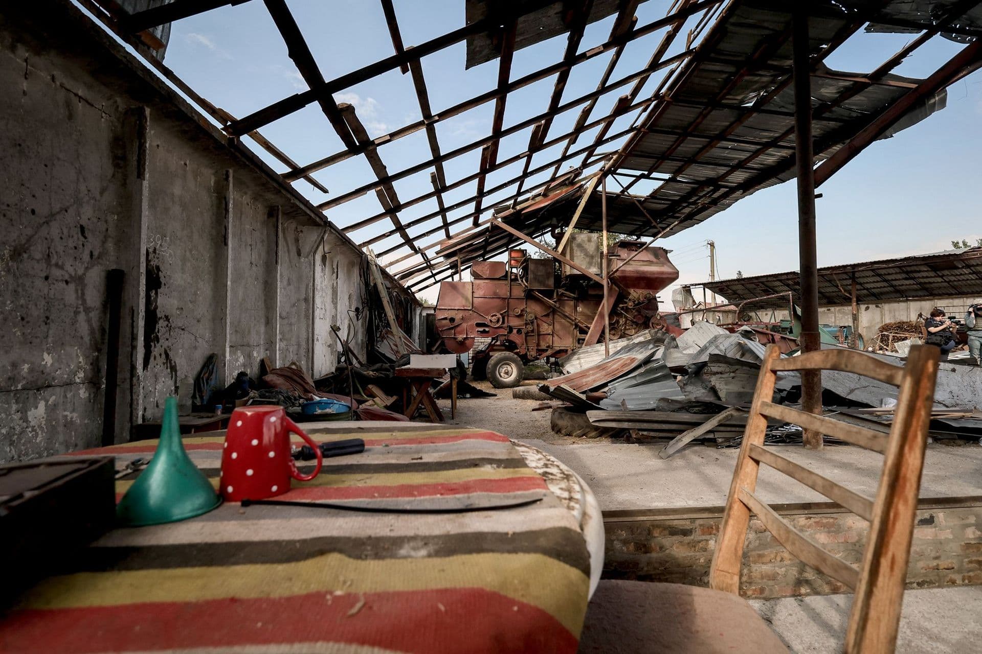 Destroyed hangar with agricultural machinery