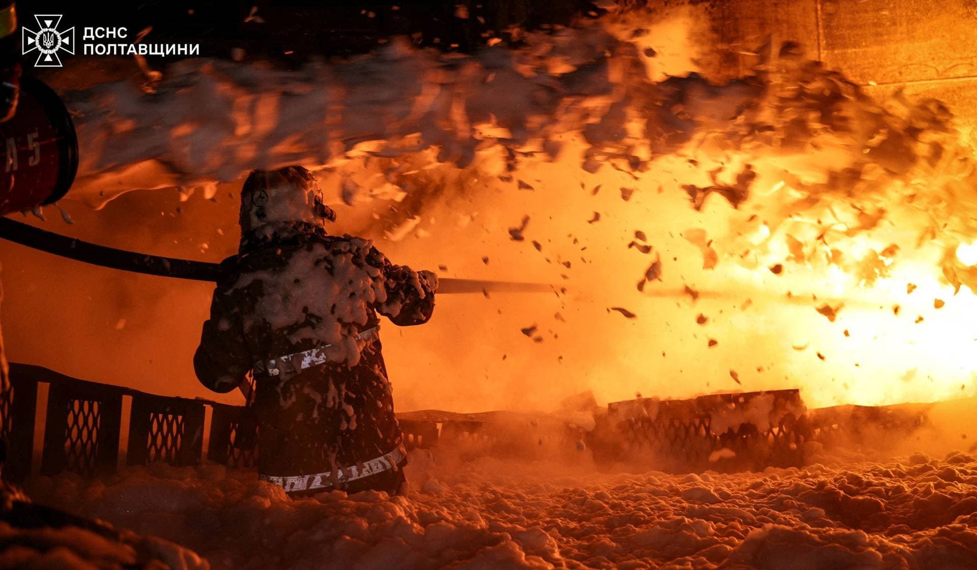 A firefighter works at the site of an industrial enterprise hit by overnight Russian drone strikes in Poltava Region
