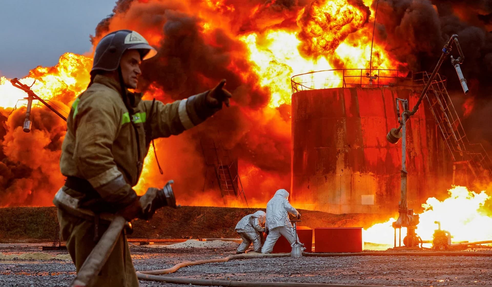 Firefighters work to extinguish fire following recent shelling at an oil storage facility in Shakhtarsk