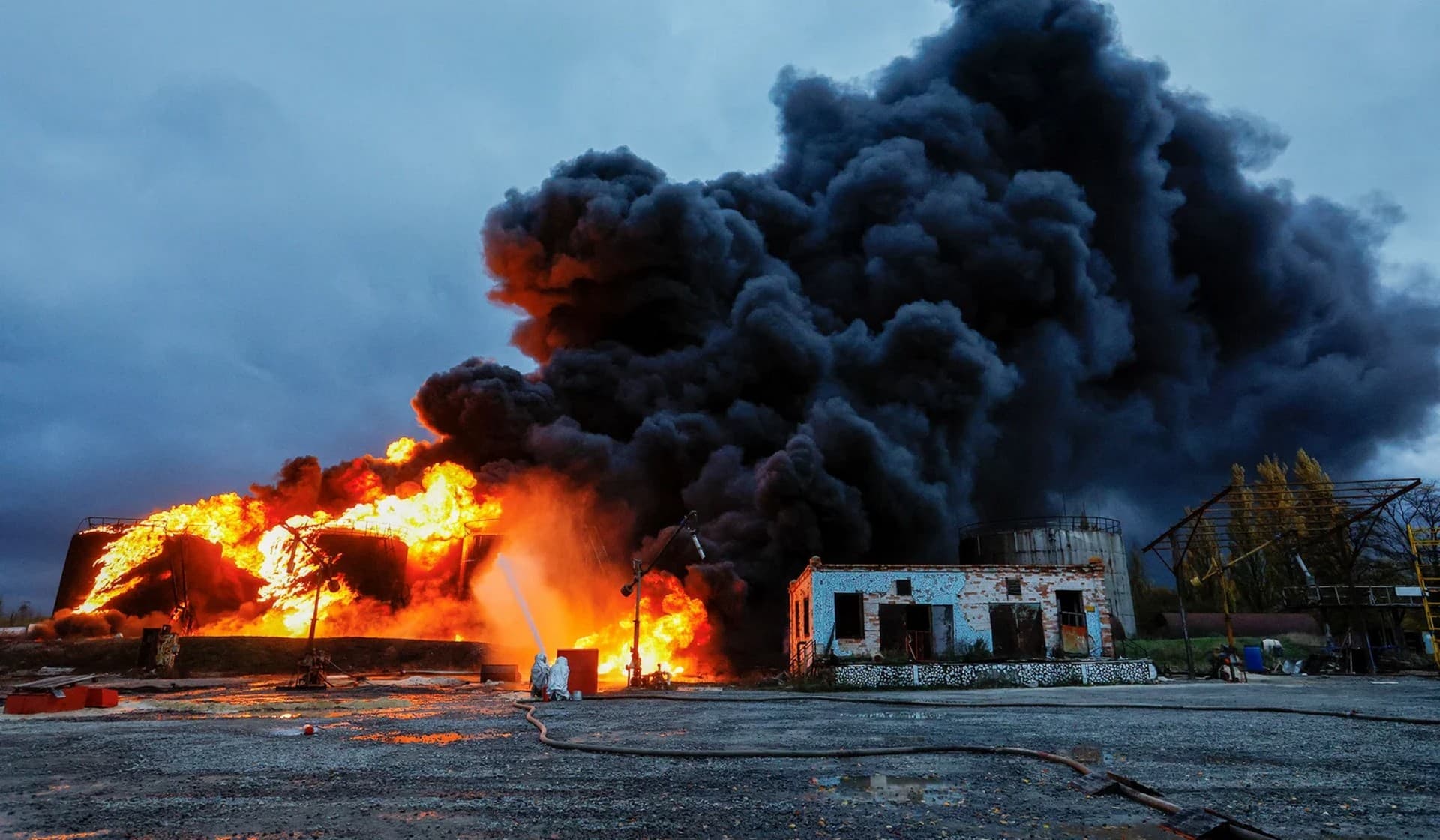 Firefighters work to extinguish fire following recent shelling at an oil storage facility in Shakhtarsk