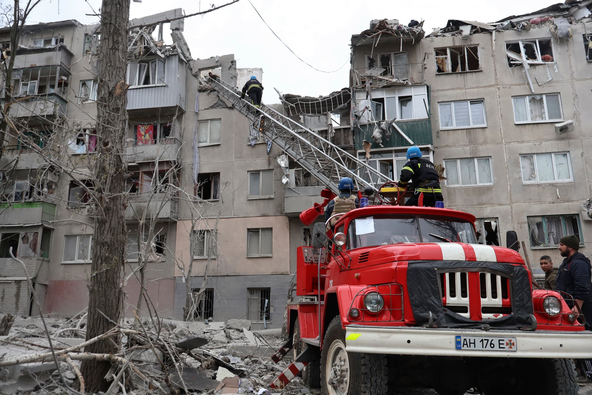 A local resident looks at his home, damaged by a Russian rocket attack in Sloviansk