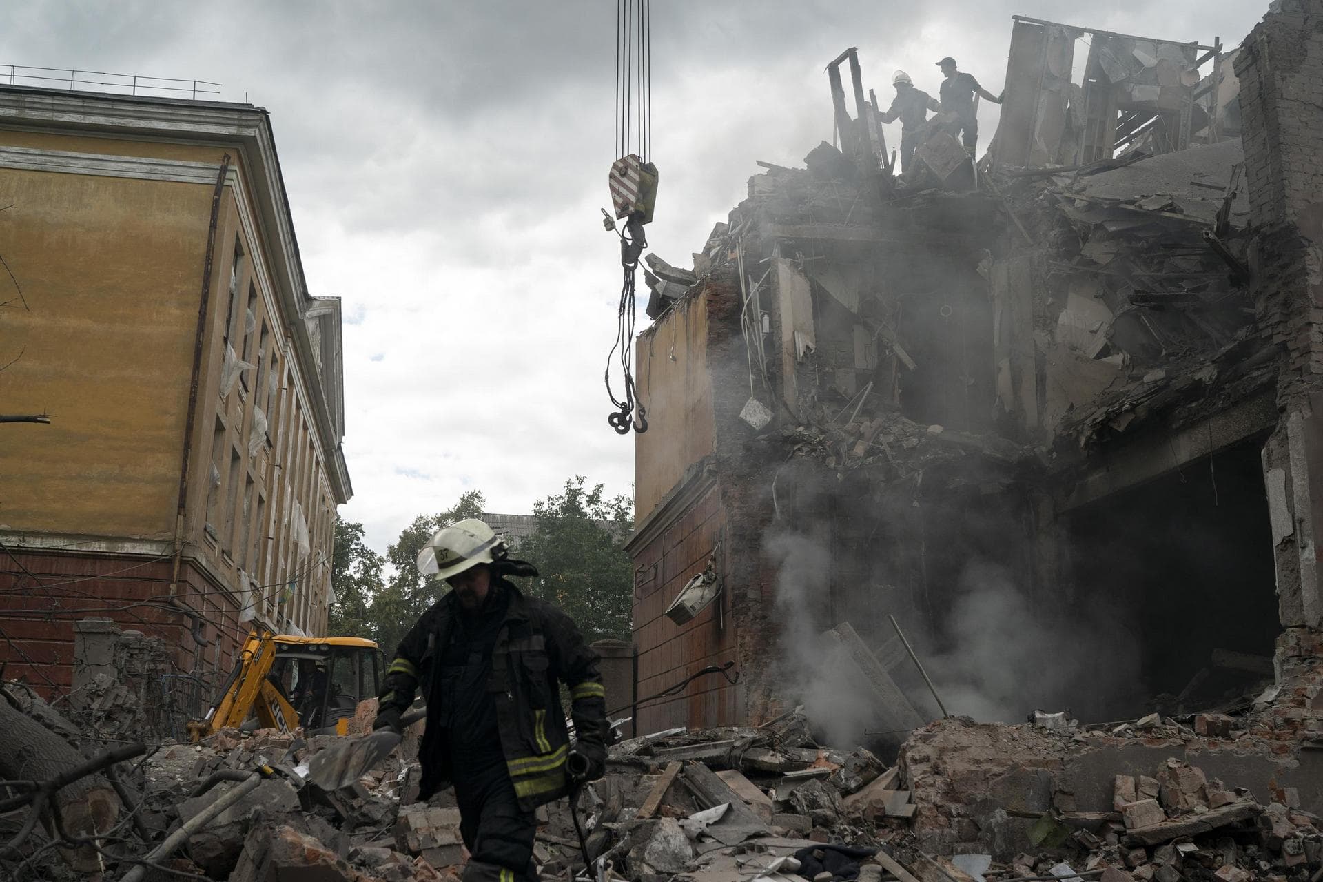 A firefighter works to extinguish a fire after a Russian attack that heavily damaged a residential building in Sloviansk