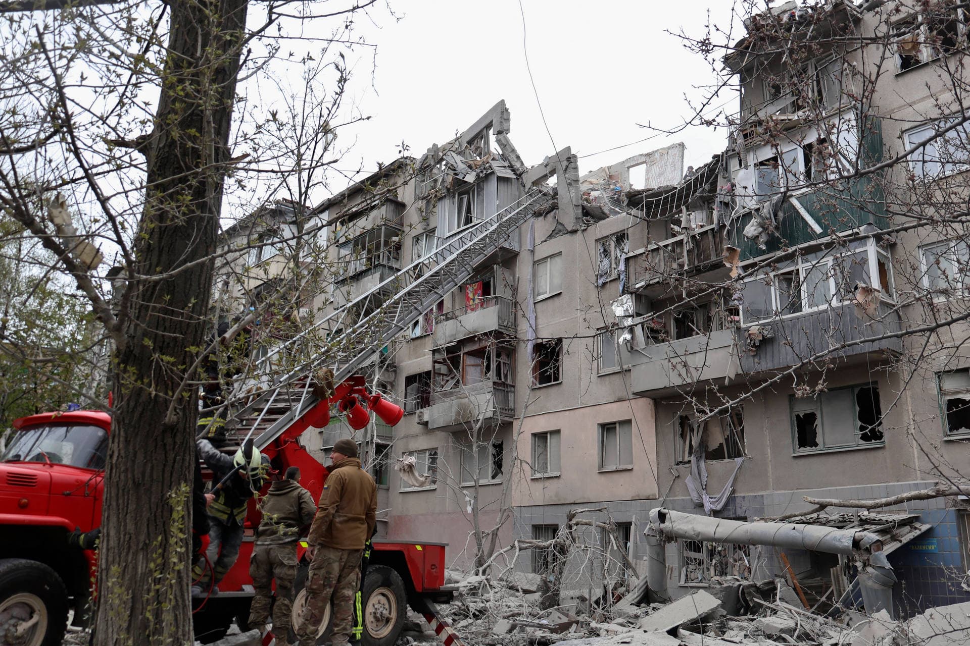 A local resident looks at his home, damaged by a Russian rocket attack in Sloviansk