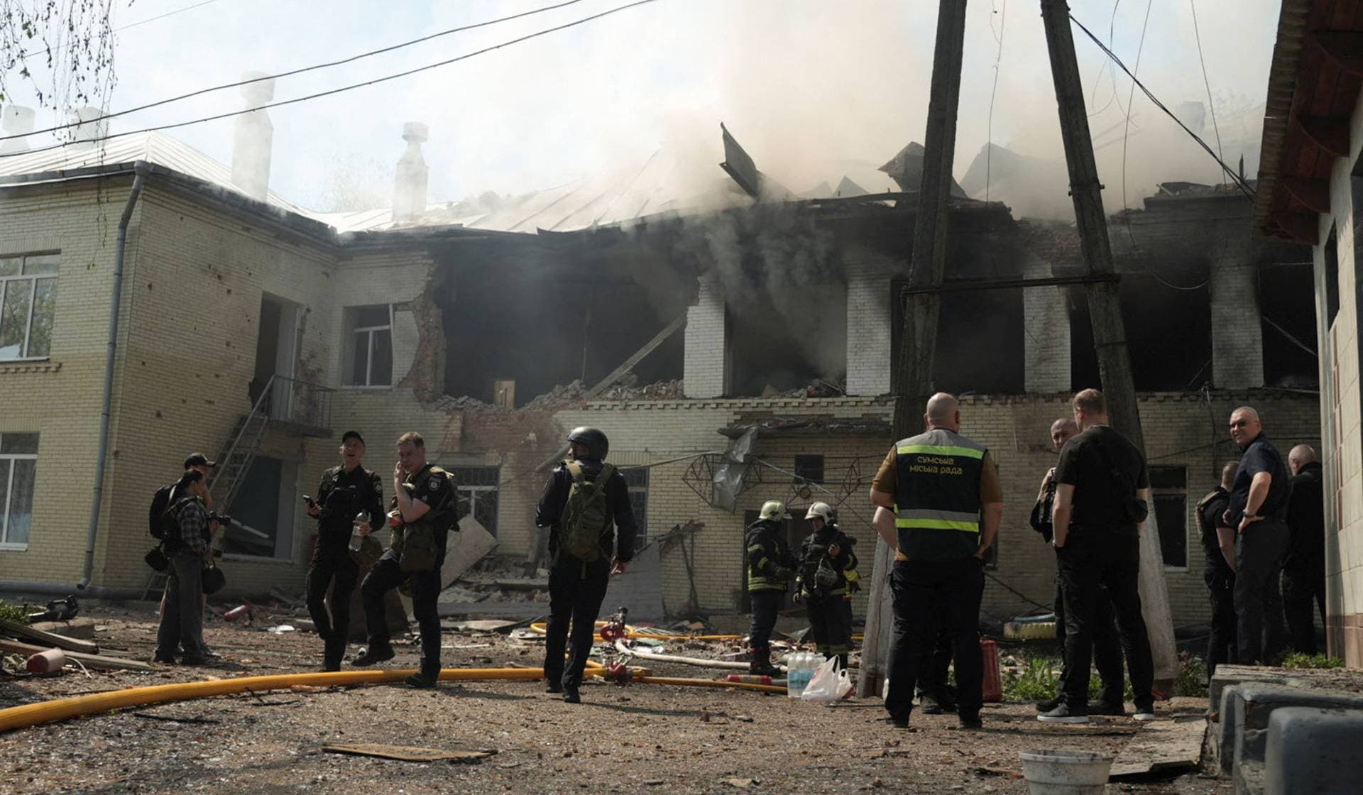 Rescuers work at the site of the kindergarten hit by a Russian drone strike in Sumy