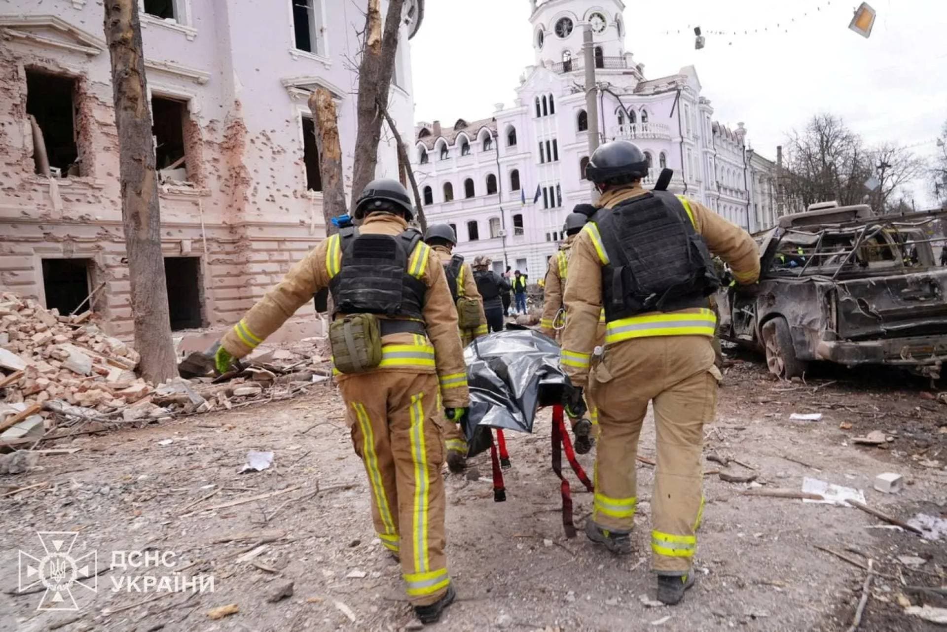 Members of emergency services work at the site of a Russian missile strike in Sumy