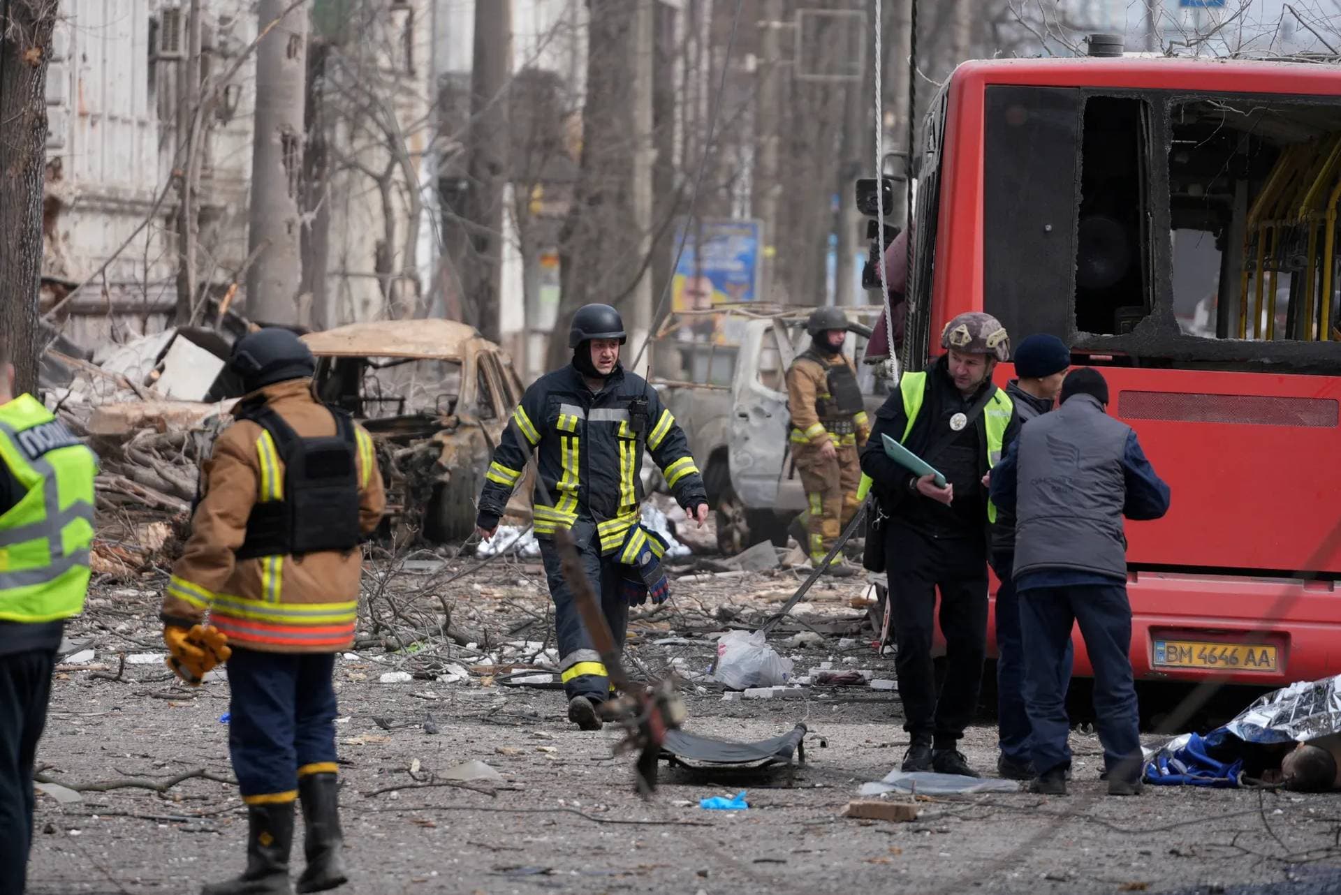 Members of emergency services work at the site of a Russian missile strike in Sumy