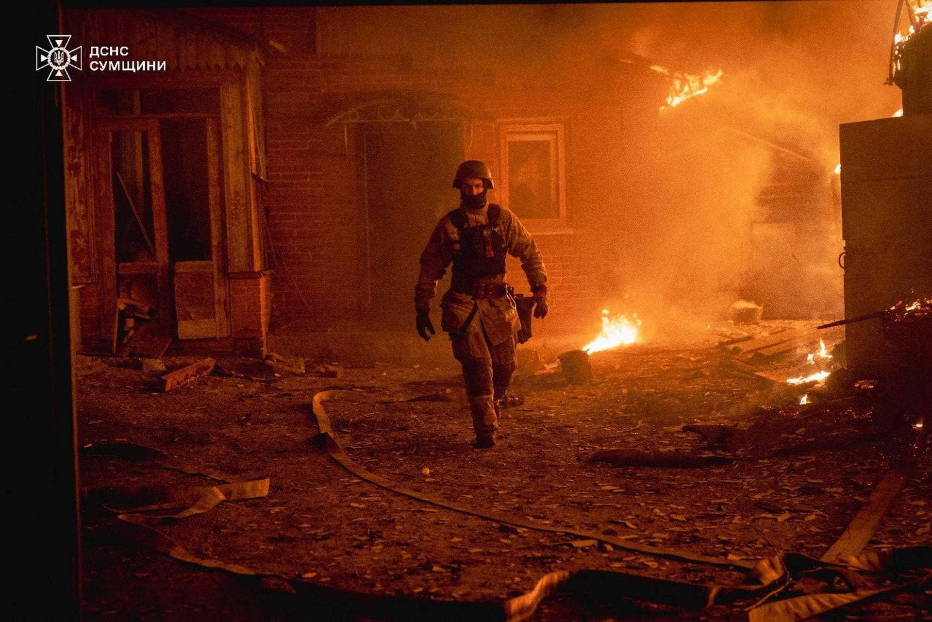 A firefighter works at the site of a Russian military strike in Sumy Region