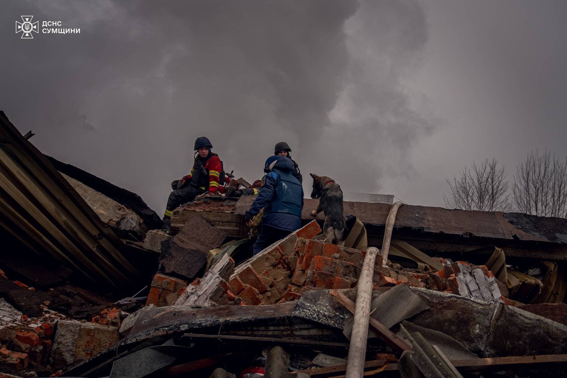 Firefighters work at the site of a Russian military strike in Sumy