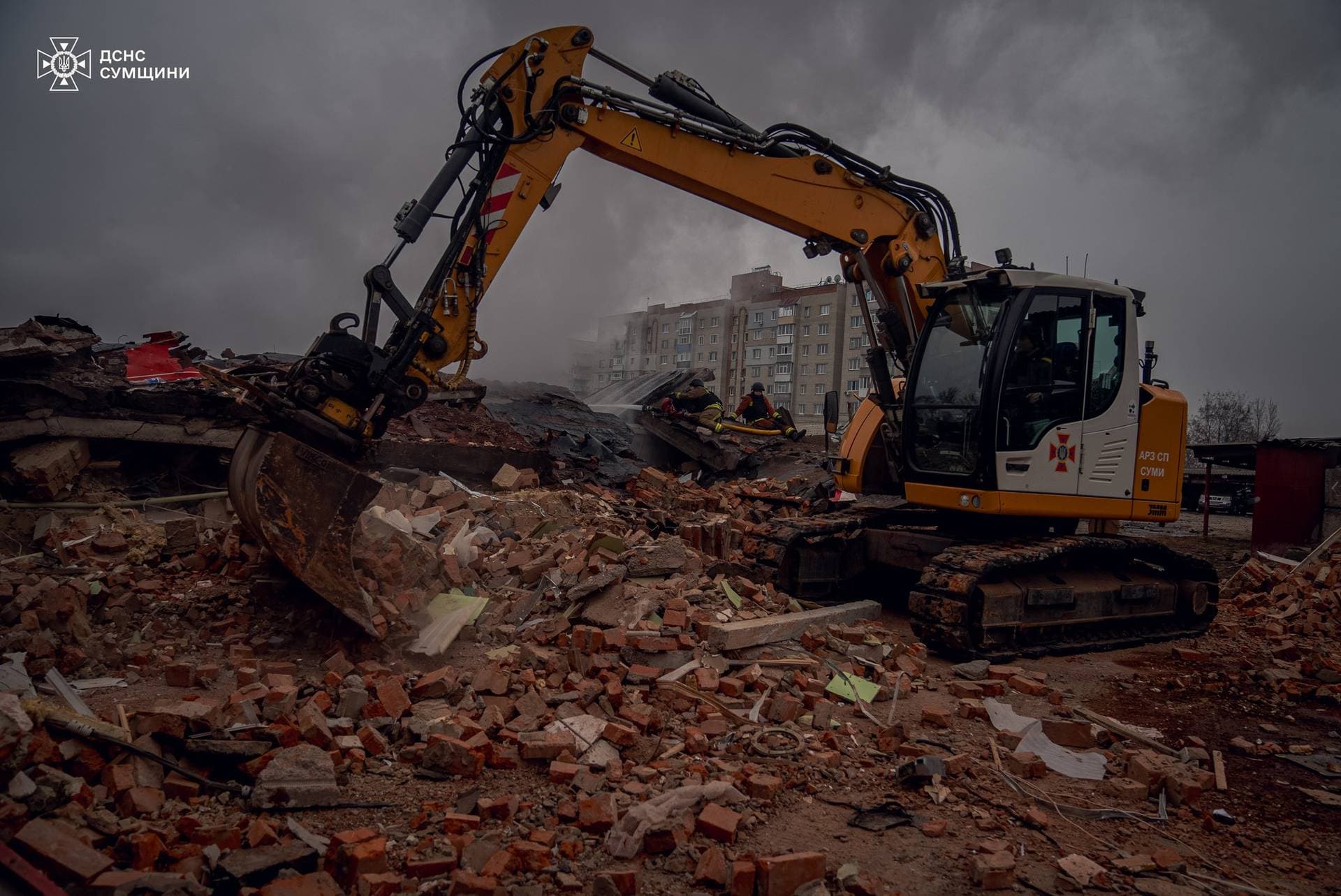 Firefighters work at the site of a Russian military strike in Sumy