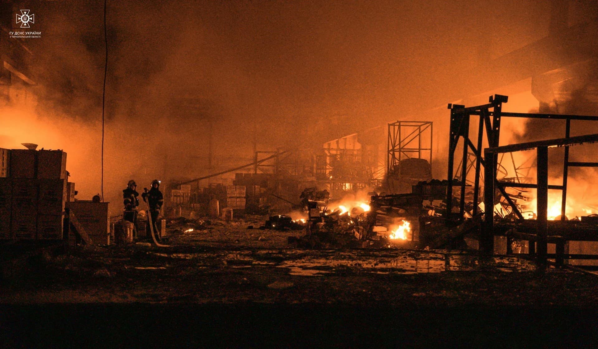 Firefighters work at a site of warehouse damaged by a Russian missile strike in Ternopil.