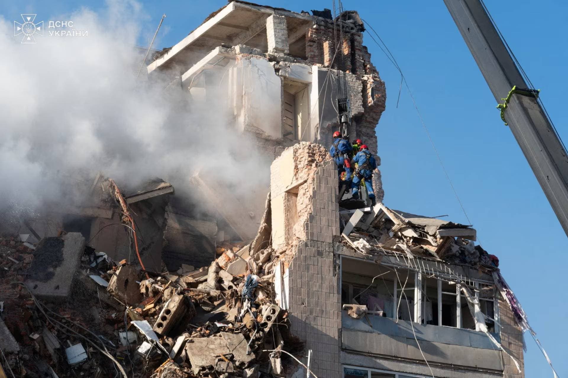 Rescuers work at the site of an apartment building hit by a morning Russian missile strike in Ternopil