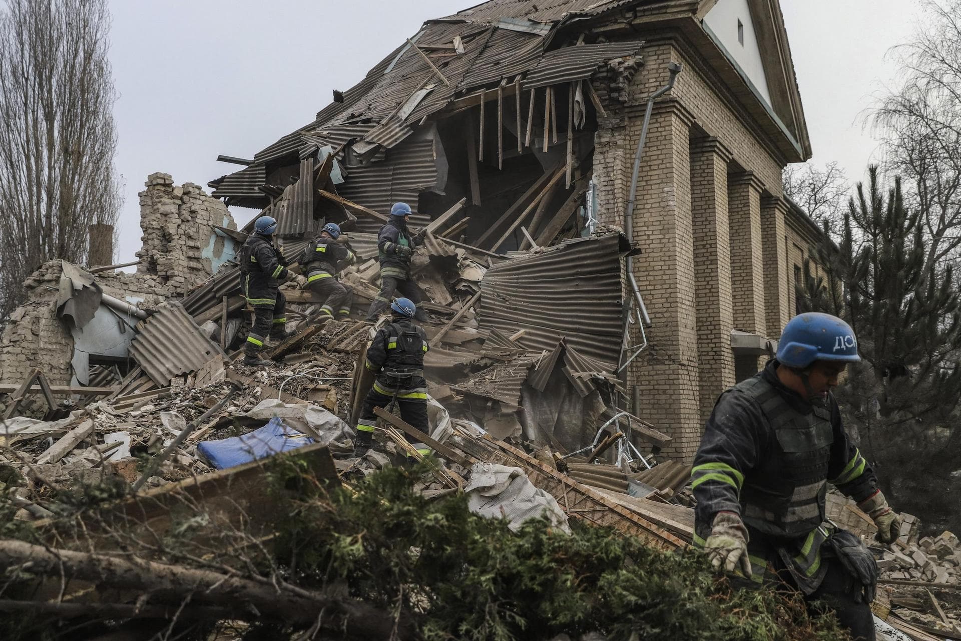 Ukrainian firefighters work at a damaged hospital maternity ward in Vilniansk